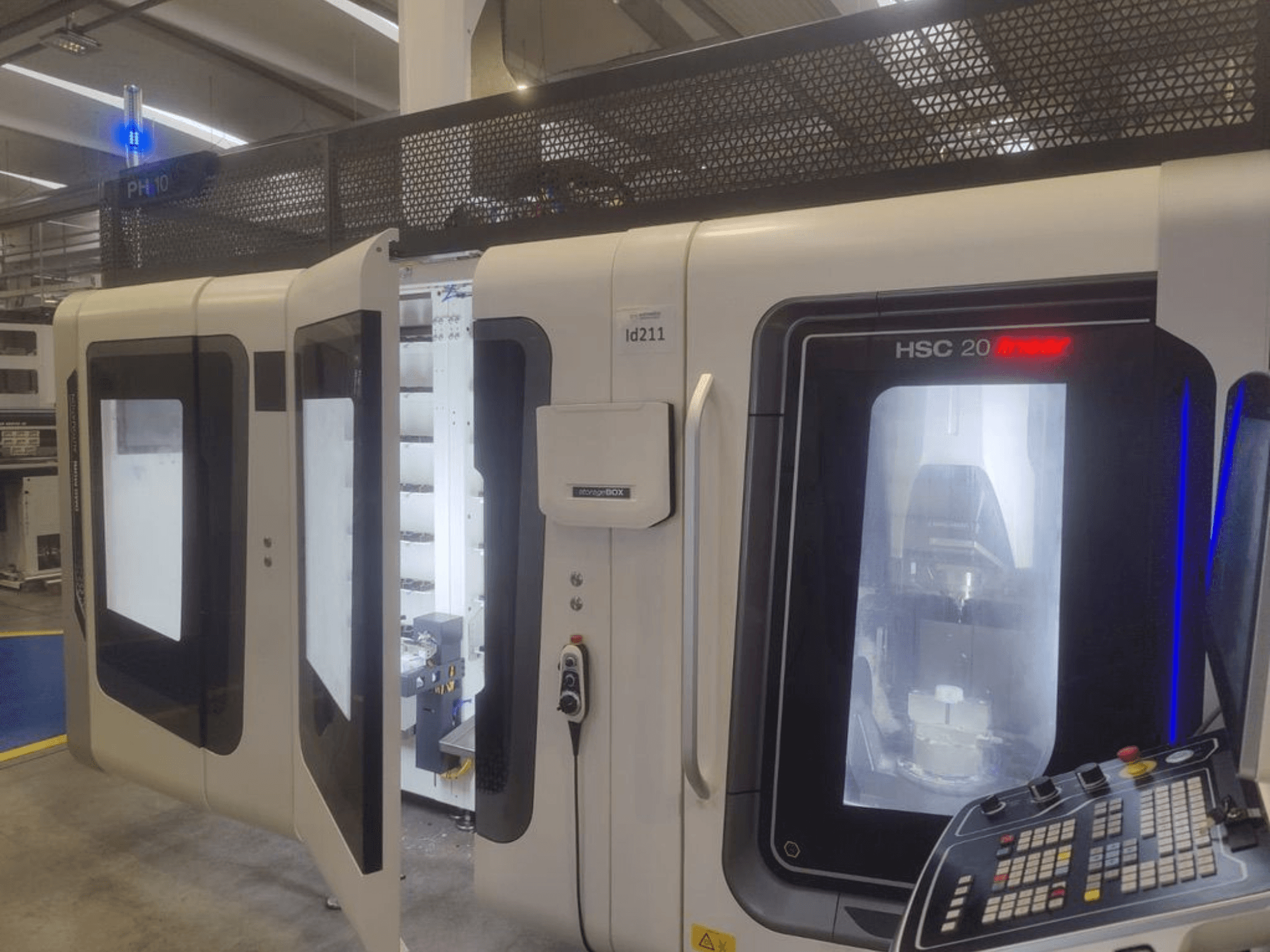 DMG MORI HSC 20 vertical machining center, front view, showcasing open doors revealing the machining interior and control panel.