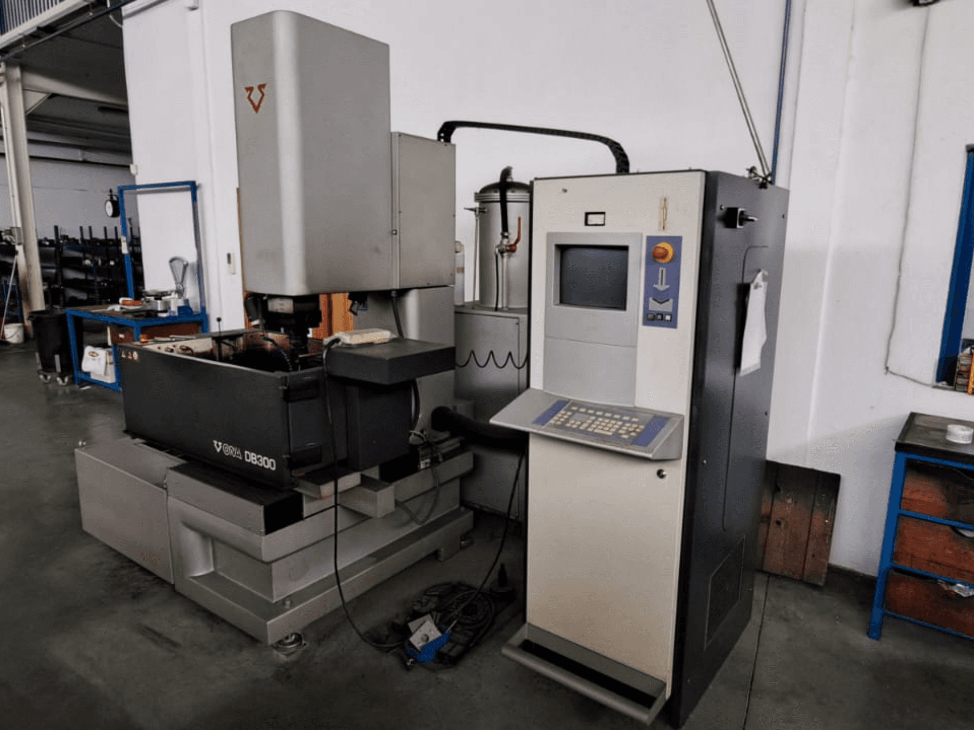 Die-Sinking EDM machine ONA DB300, front view; featuring control panel, workpiece holder, and industrial design elements.