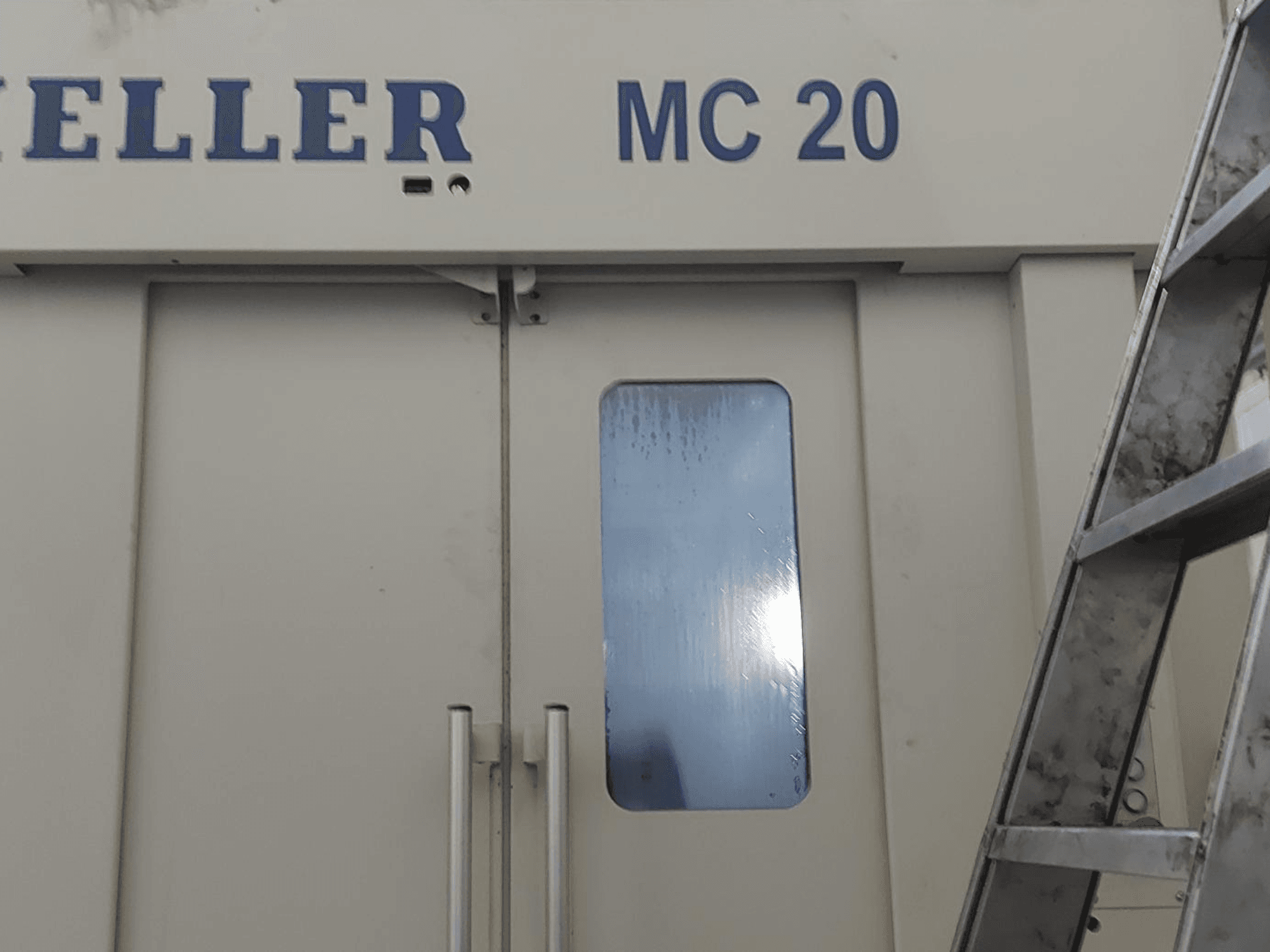 Heller MC 20 Horizontal Machining Centre front view, featuring dual doors and a side window reflecting light.