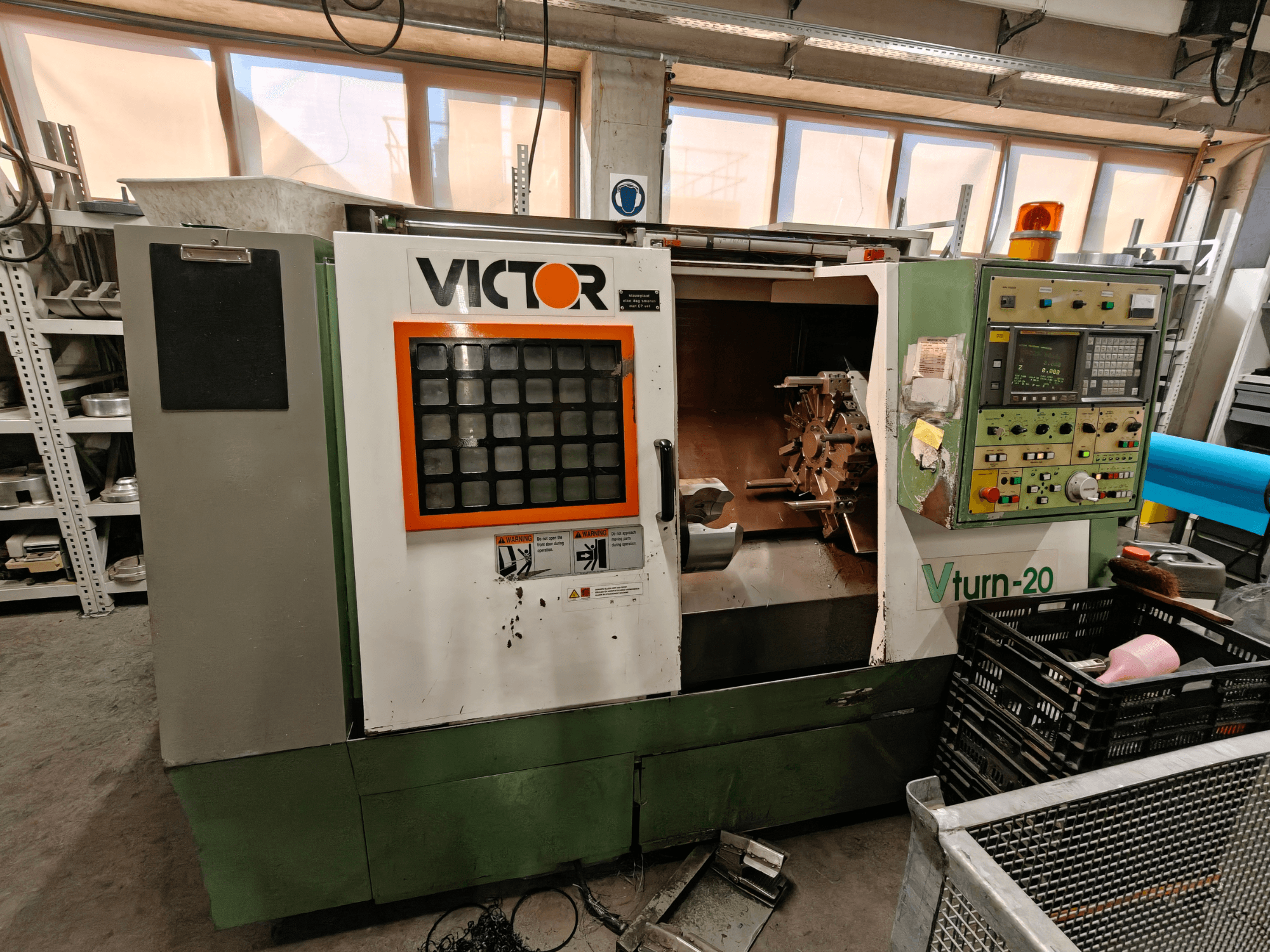 Victor Vturn-20 horizontal turning machine, side view, showcasing control panel, spindle, and workspace for machining.