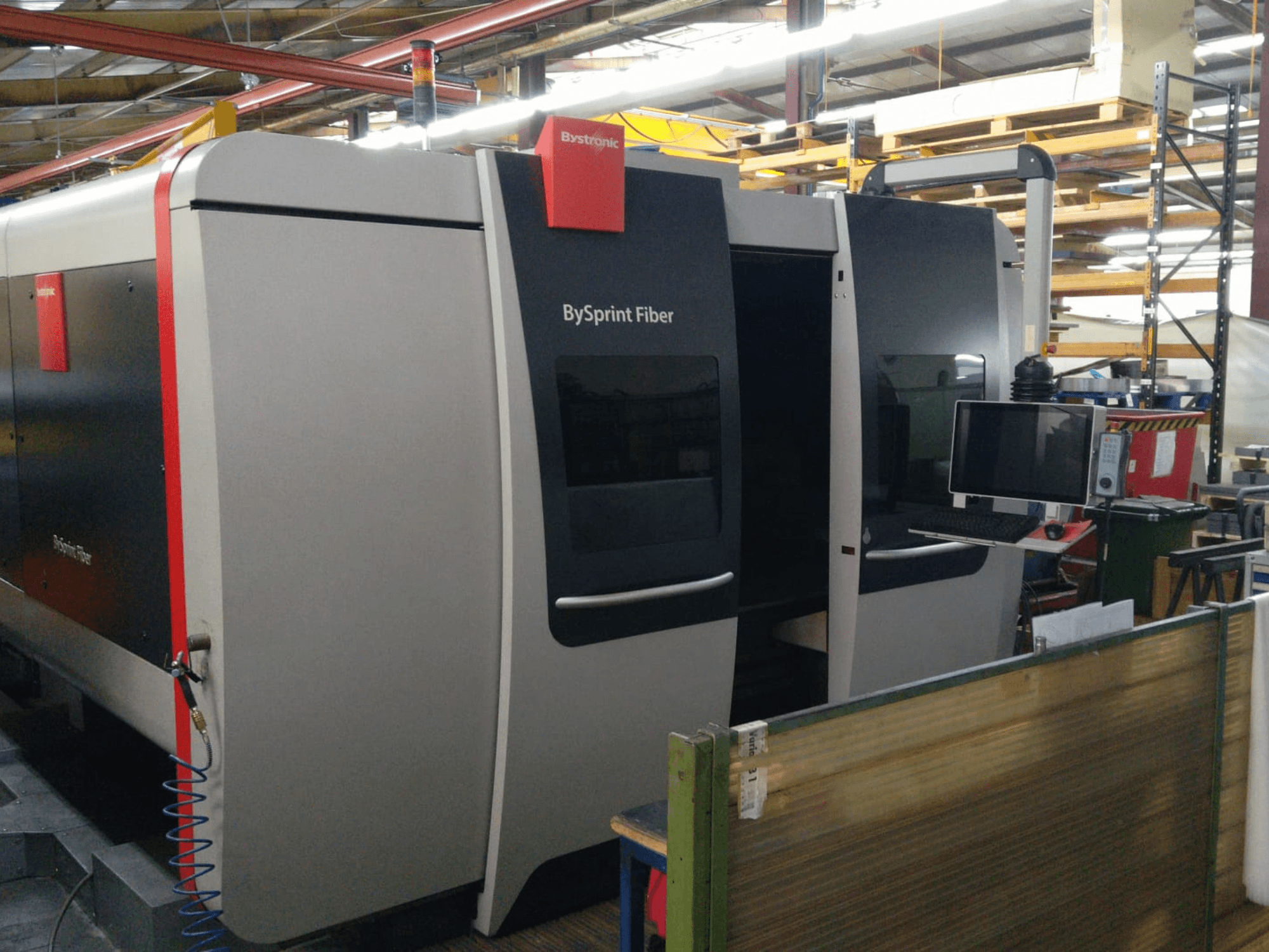 Bystronic BySprint Fiber laser cutter, front view with control panel, visible details include two doors and a monitor on the side.