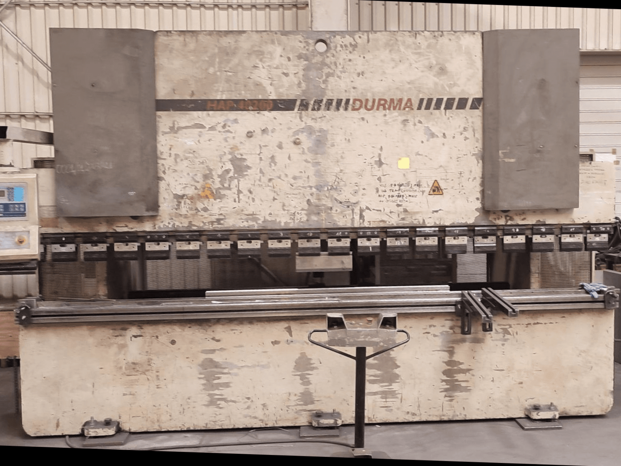 Durma HAP 40200 press brake front view, featuring a worn exterior, control panel, and clamping tools visible on the work surface.