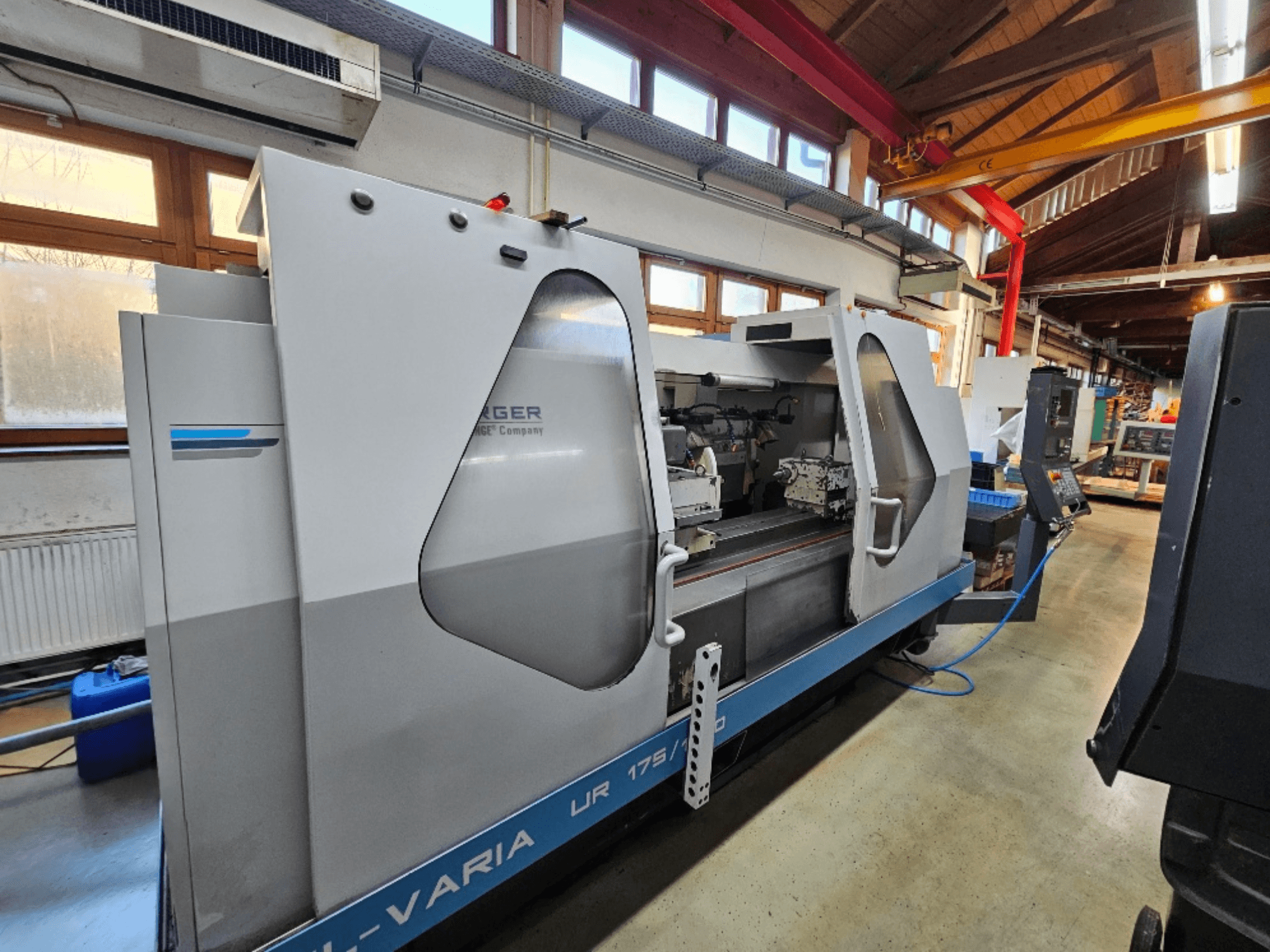 CNC machine from Burg, model UR 175/300, side view. Features a sleek design with visible controls and work area.