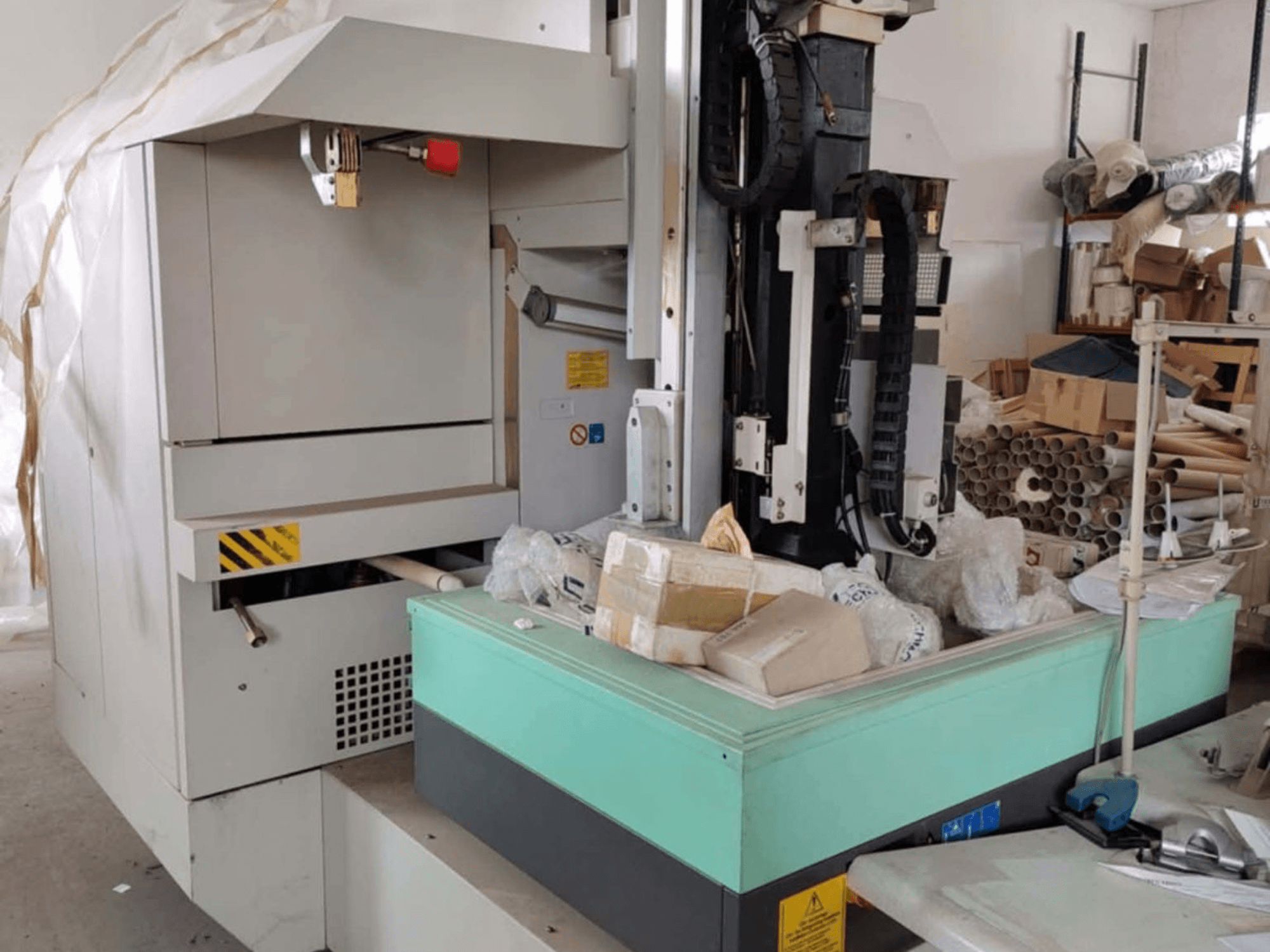 AGIE AGIETRON INTEGRAL 2 die-sinking EDM machine, front view, showing control panel, work table and surrounding clutter.