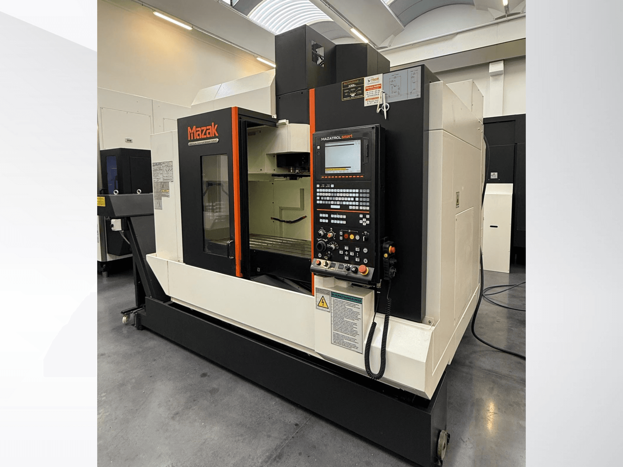 Mazak CNC machine, front view, featuring a control panel and a spacious work area with precision cutting tools.