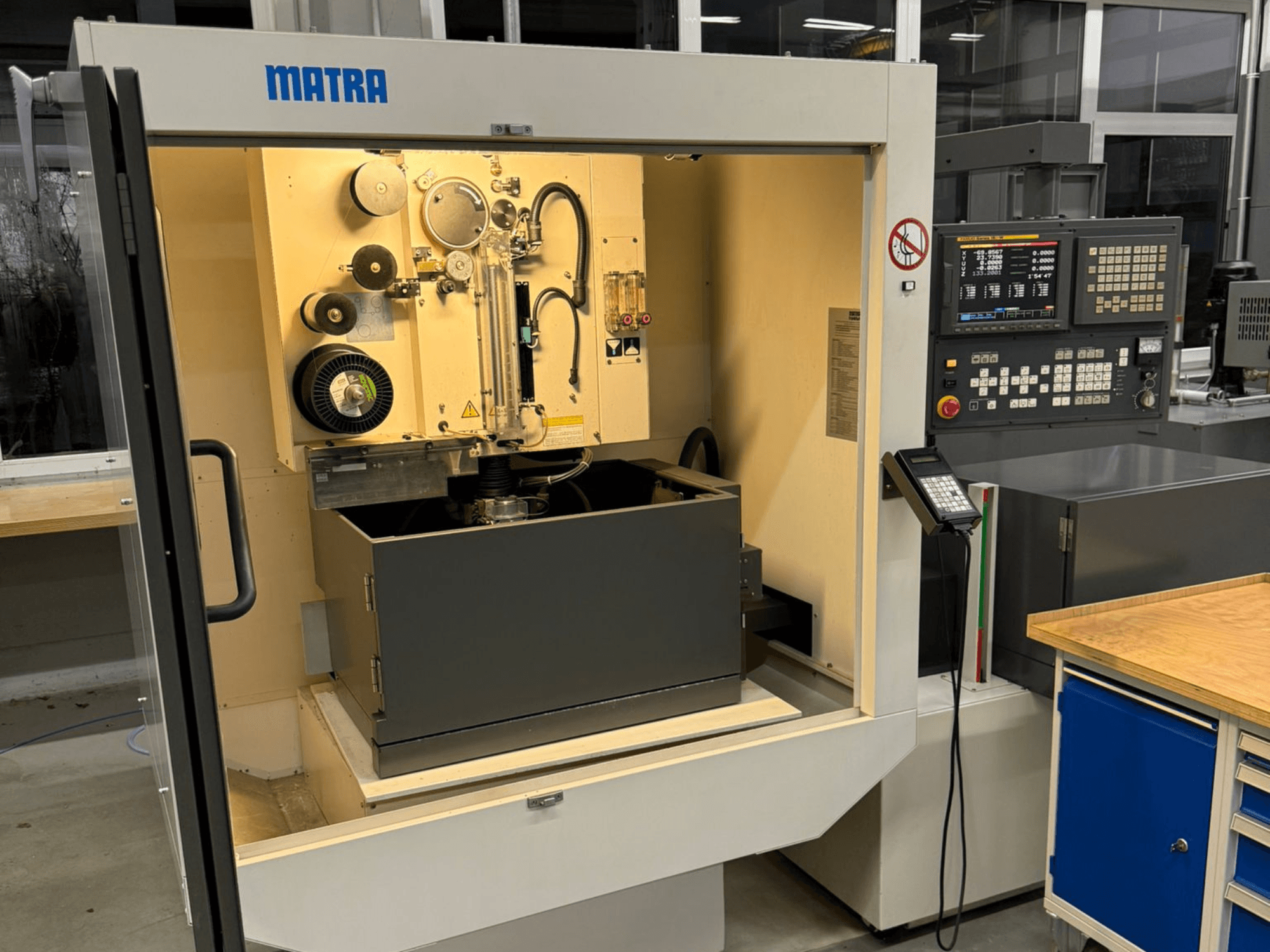 MATRA machine viewed from the front, featuring control panel, rotating parts, and a large storage compartment.