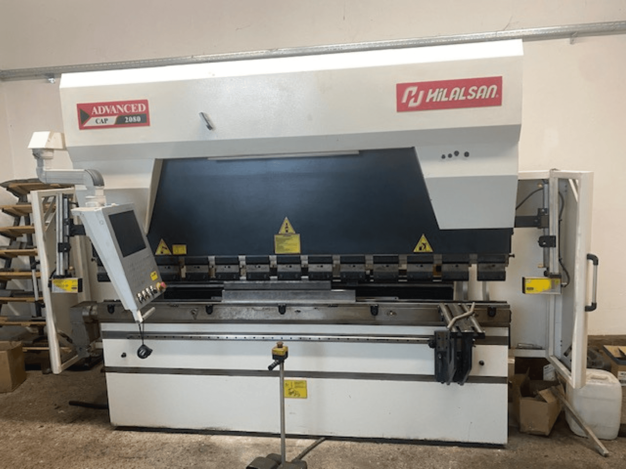 Advanced Hilalsan CAP 2080 press brake, front view with control panel and safety features, industrial design for metal bending.