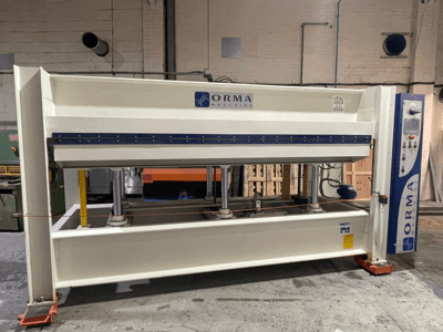 ORMA machinery hydraulic press, front view, with silver finish, control panel on the right, and upright pistons for pressing.