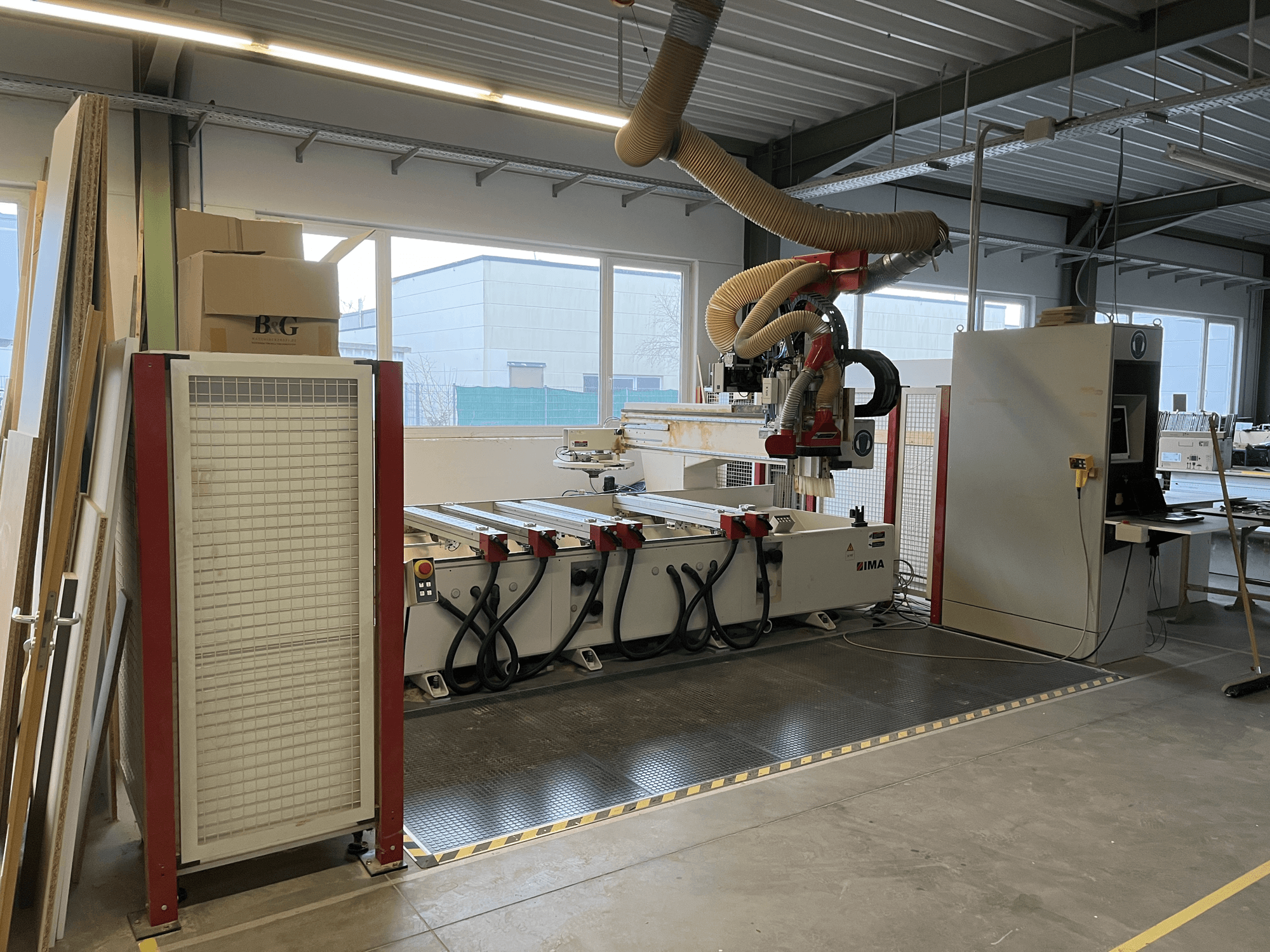 CNC Wood Machining Centre IMA BIMA 410 in workshop, side view with control panel and dust extraction system visible.