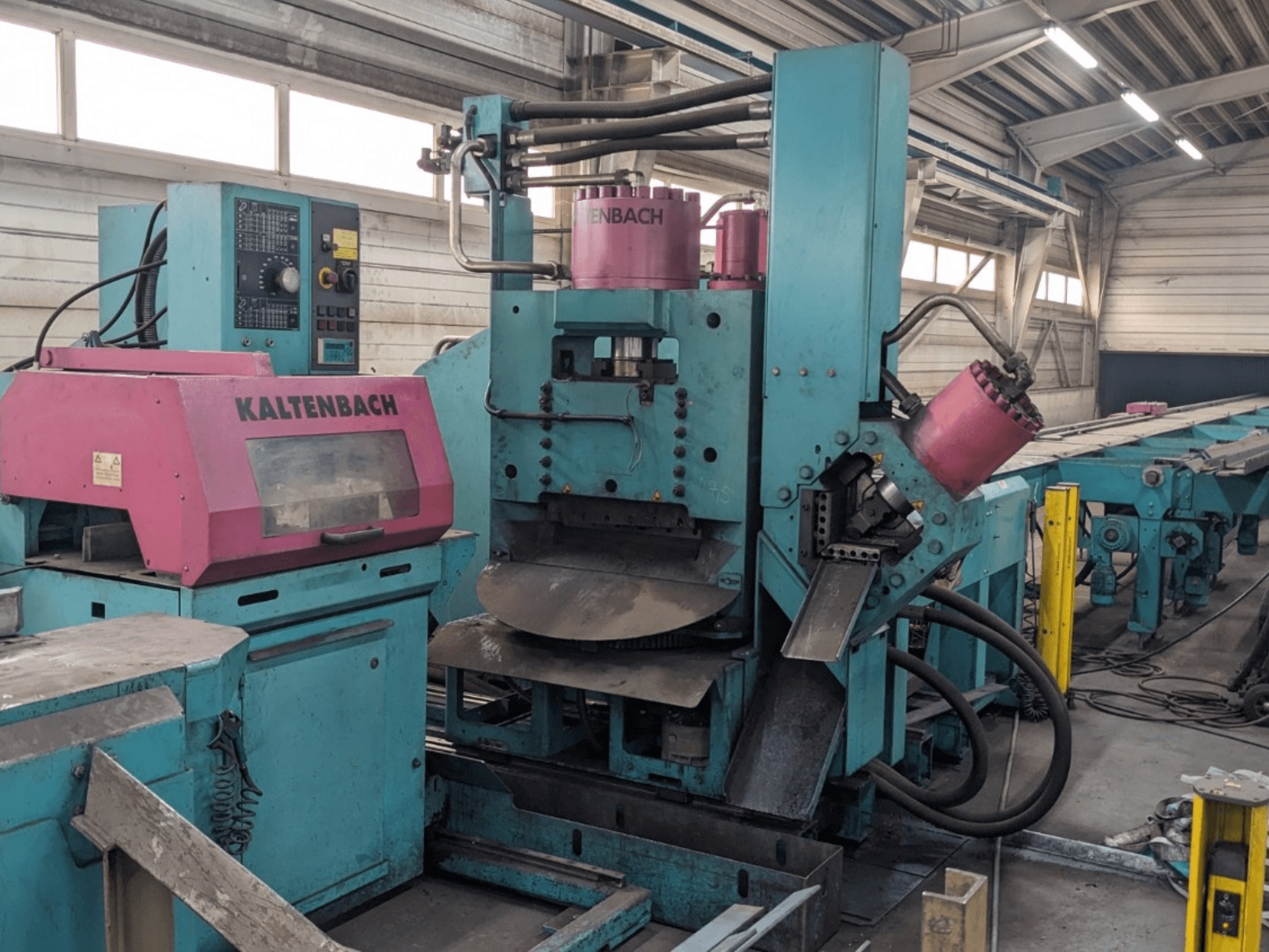 KALTENBACH industrial machine in teal and pink, front view, features control panel and hydraulic components.