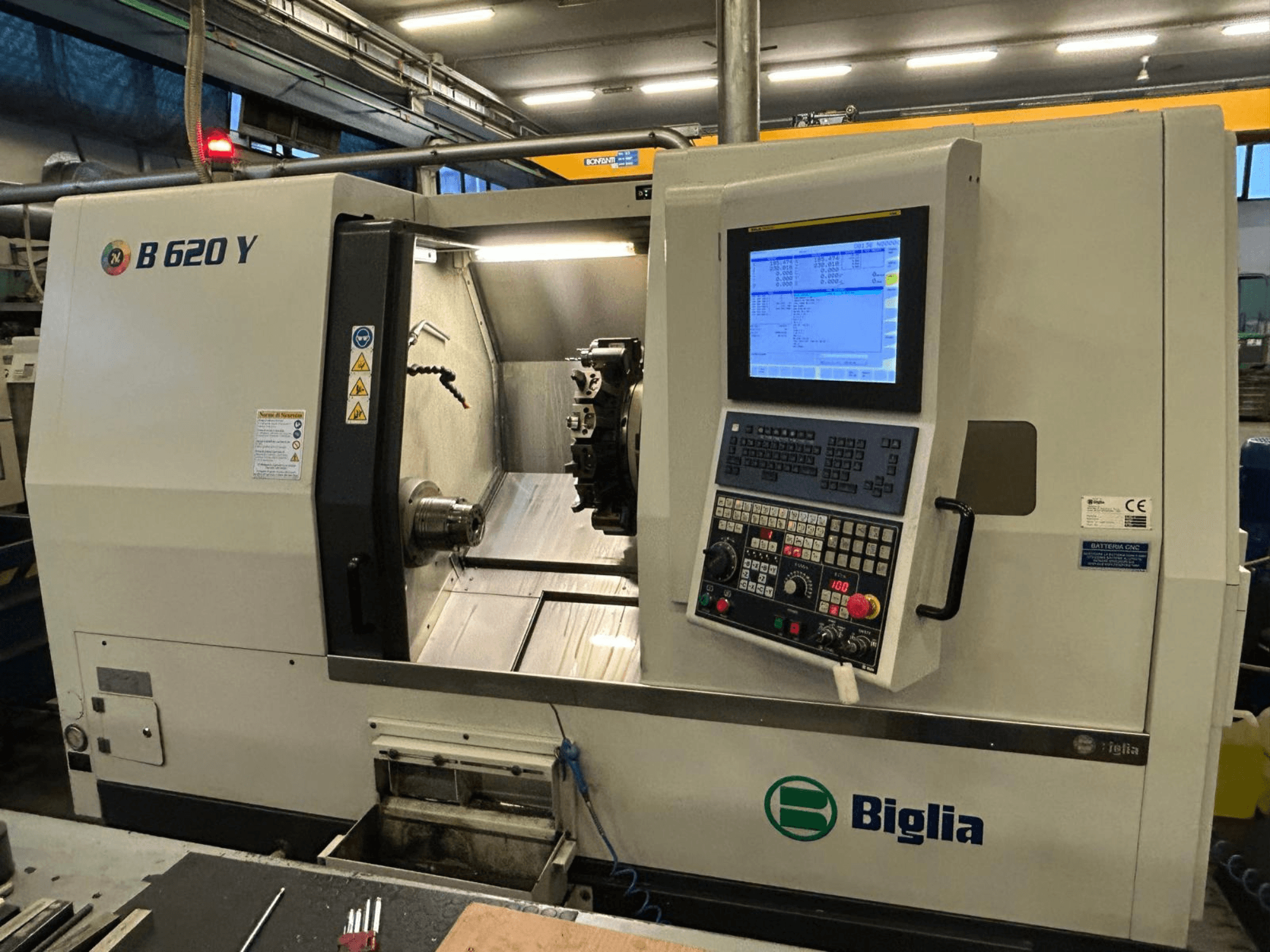 Biglia B 620 Y CNC lathe in a workshop, front view, showing control panel with digital display and machining components.