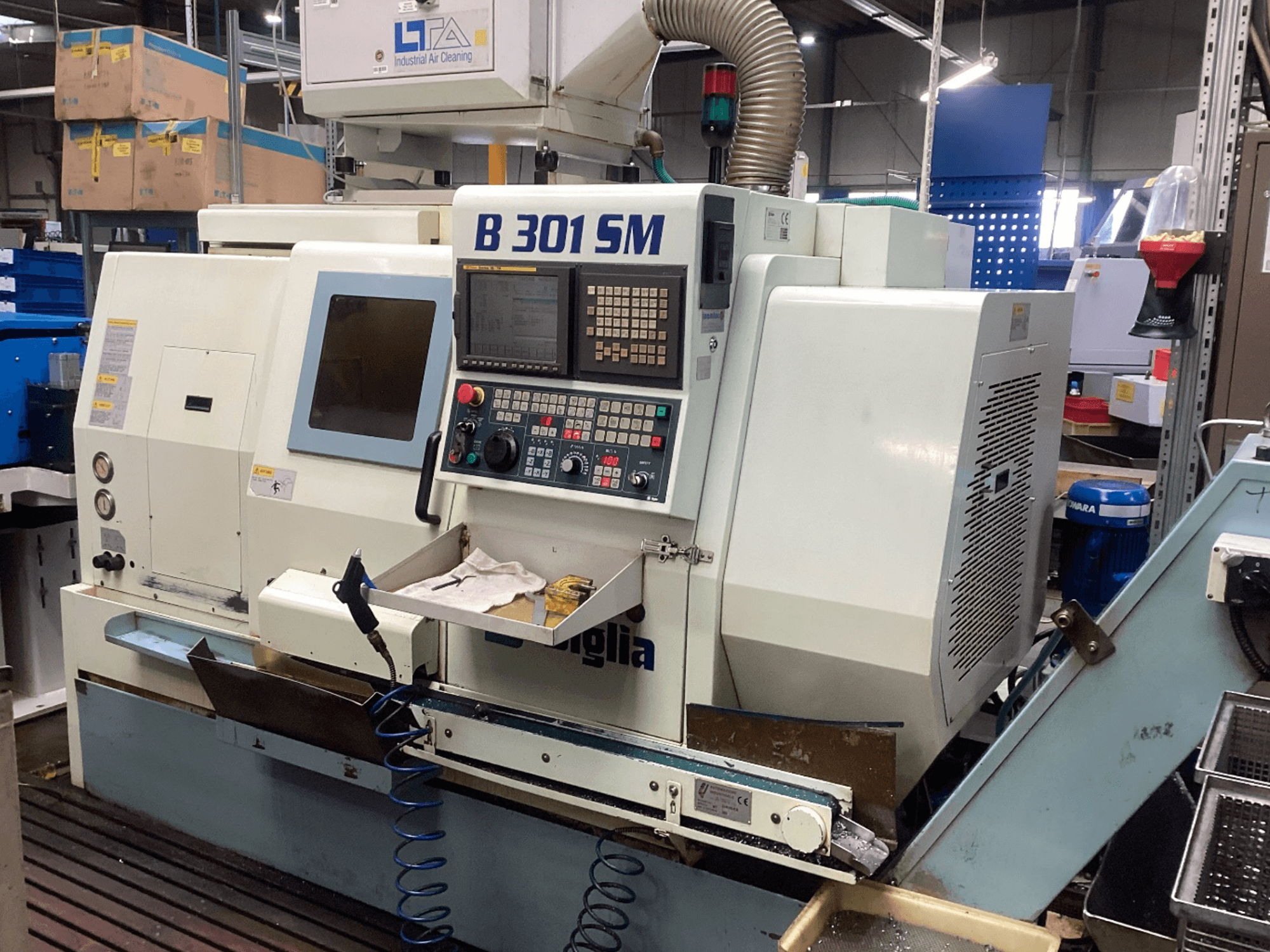 Biglia B301 SM horizontal turning machine, front view, showing control panel, coolant system, and workpiece area.