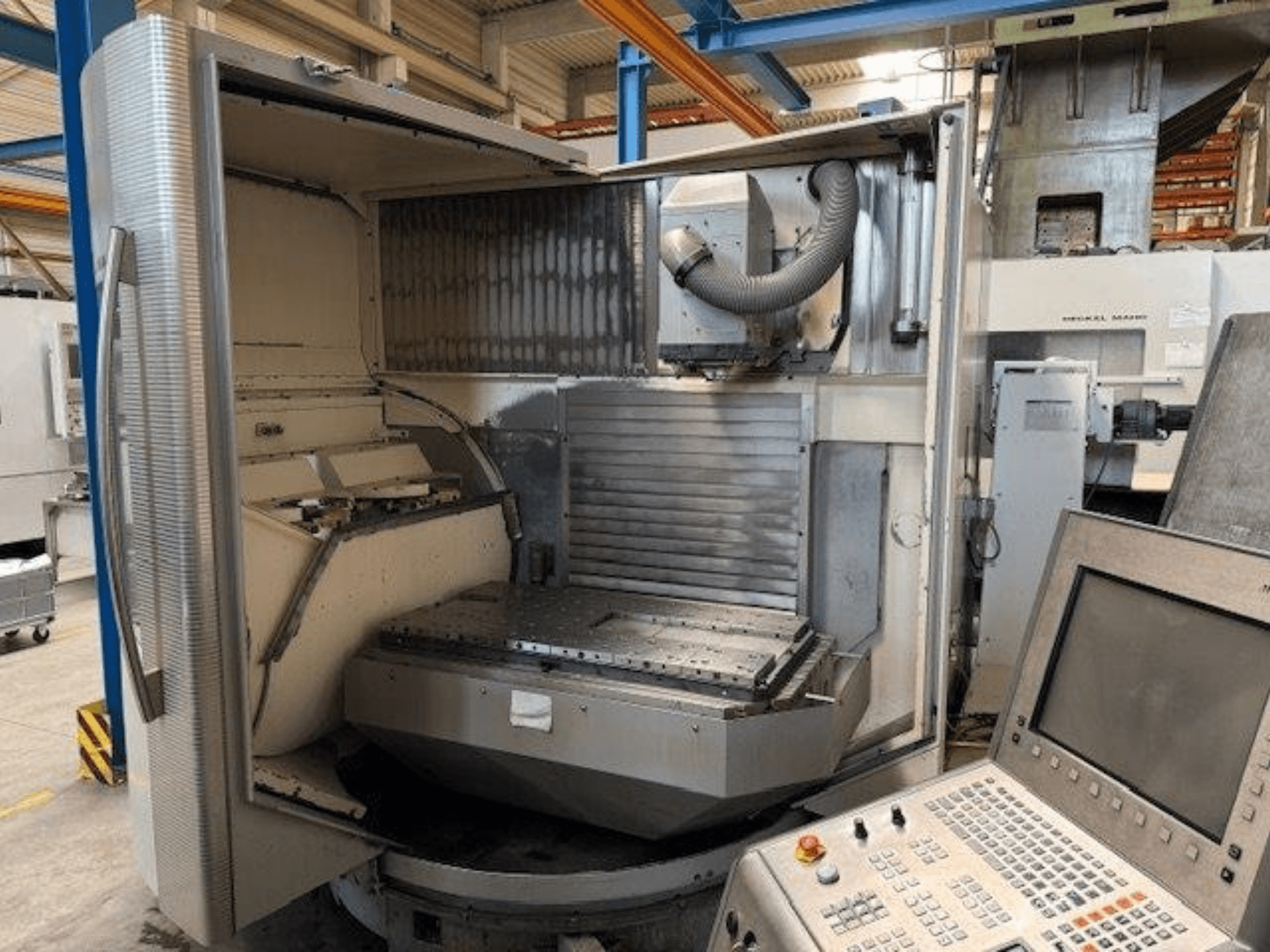 DMG MORI DMU 80T vertical machining center, front view showing open enclosure and control panel.