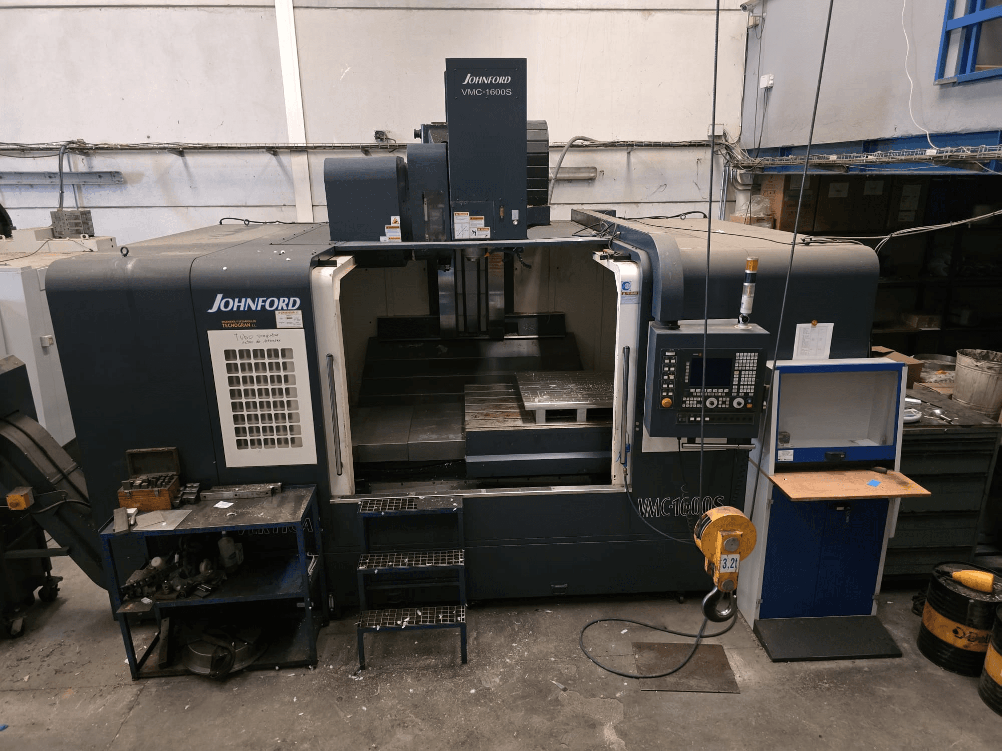 Front view of a Johnford VMC-1600S vertical machining centre with controls and a workspace, in a workshop setting.