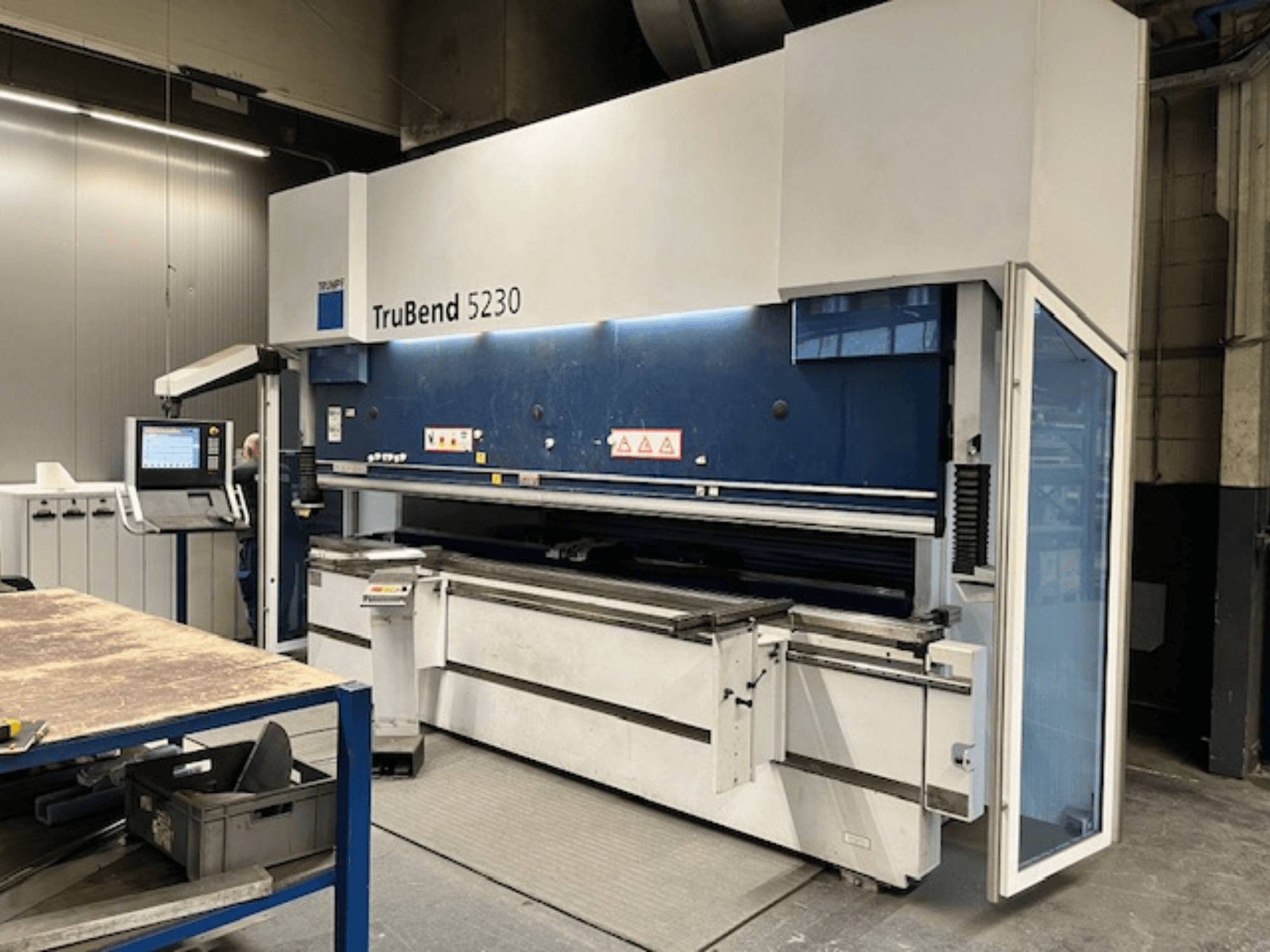 TruBend 5230 bending machine in industrial setting; front view showing control panel, safety features, and work table.