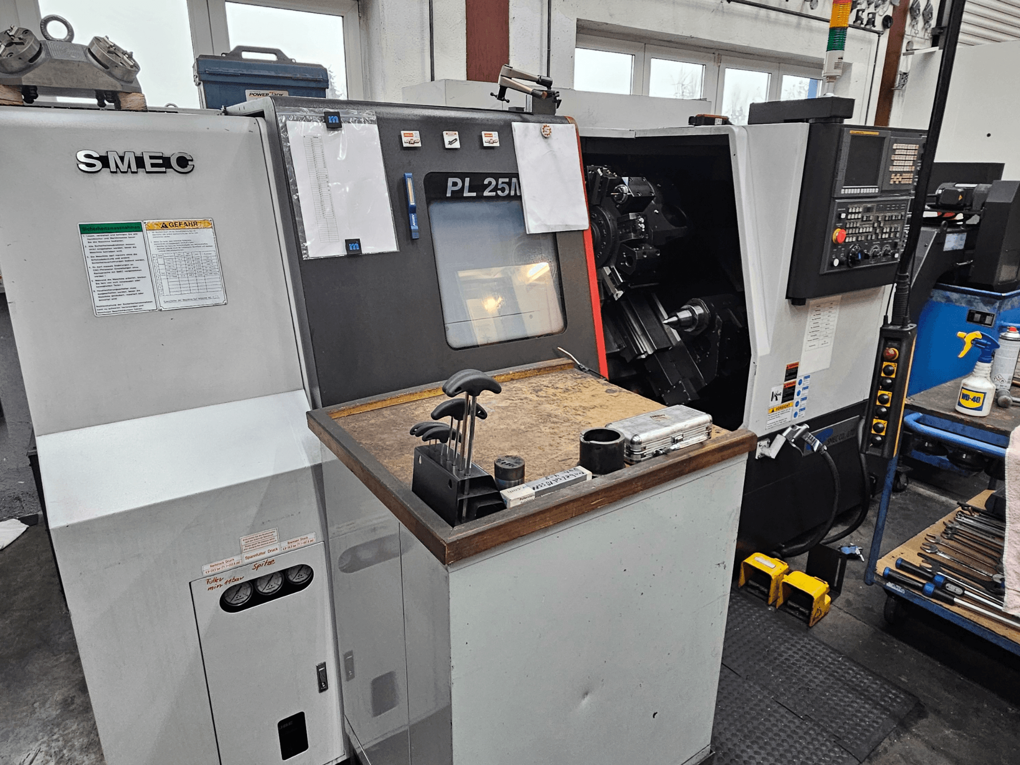 SMEC PL 25M Mill-Turn Centre in a workshop, front view showing control panel, tool holder, and operating area.