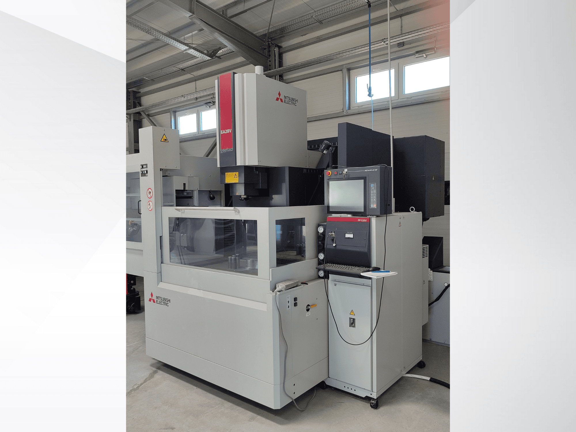 Mitsubishi Electric EA32V wire-cut EDM machine in a side view, featuring a control panel and visible work area through glass.