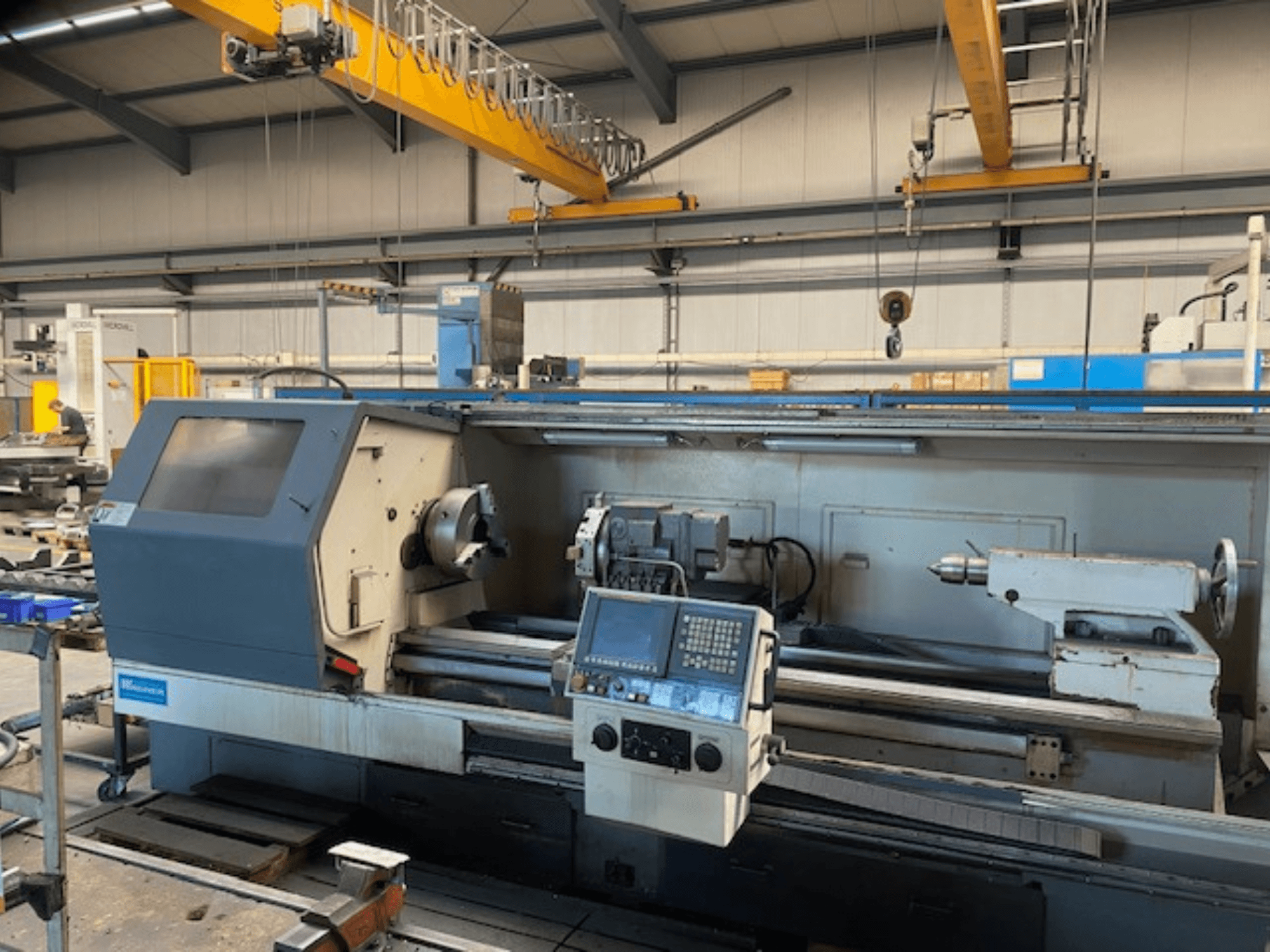 Wabeco precision lathe machine, front view with control panel, showcasing the spindle and tooling setups in a factory setting.