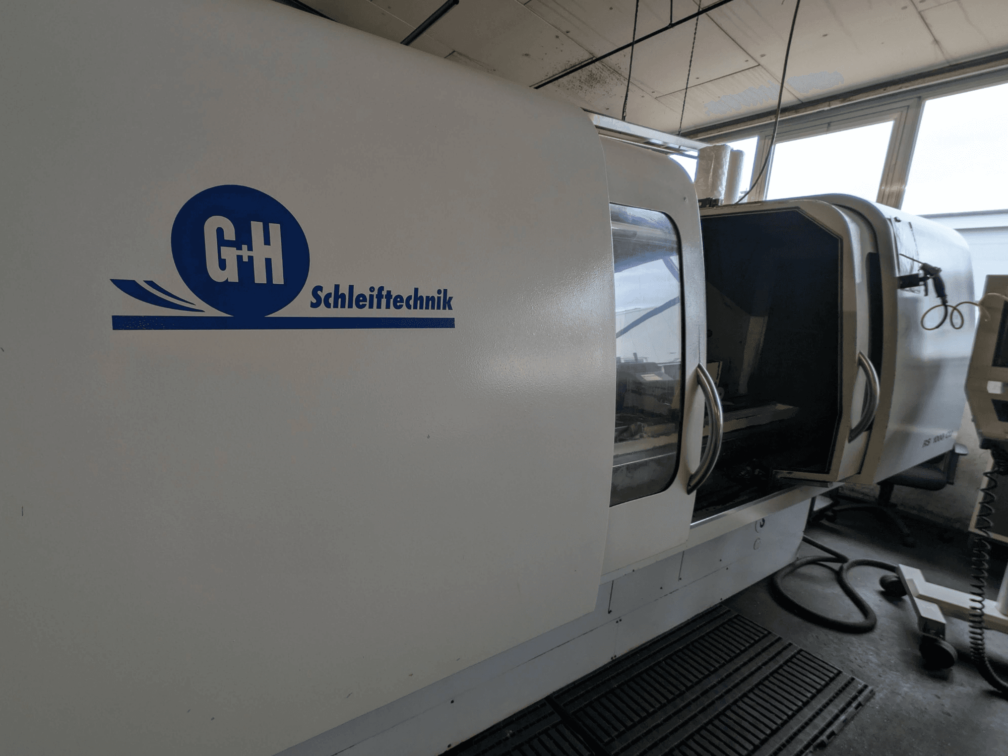 Cylindrical grinding machine GEIBEL & HOTZ RS 1000 CU, side view showing control panel and open access door.