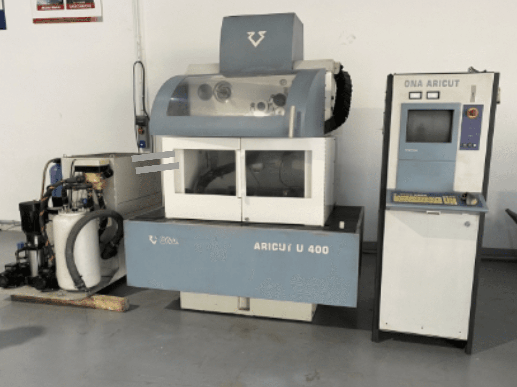 ONA U 400 Wire EDM Machine viewed from the front, featuring a control console and coolant unit on the side.