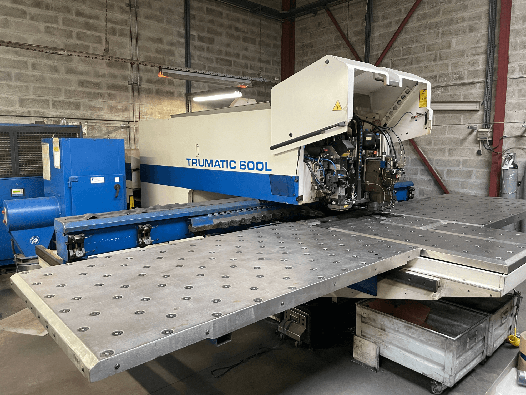 CO2 Laser Cutting Machine TRUMPF TRUMATIC TC 600L, front view with metal cutting table and control panel visible.