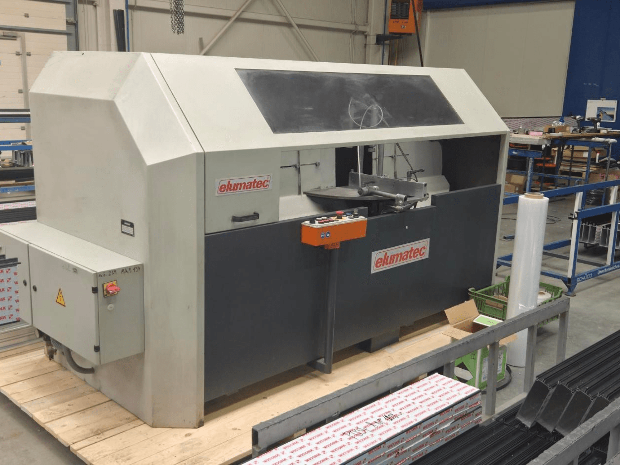 Elumatec AKS 134 circular metal saw, front view, showcasing control panel and cutting area on a wooden platform.