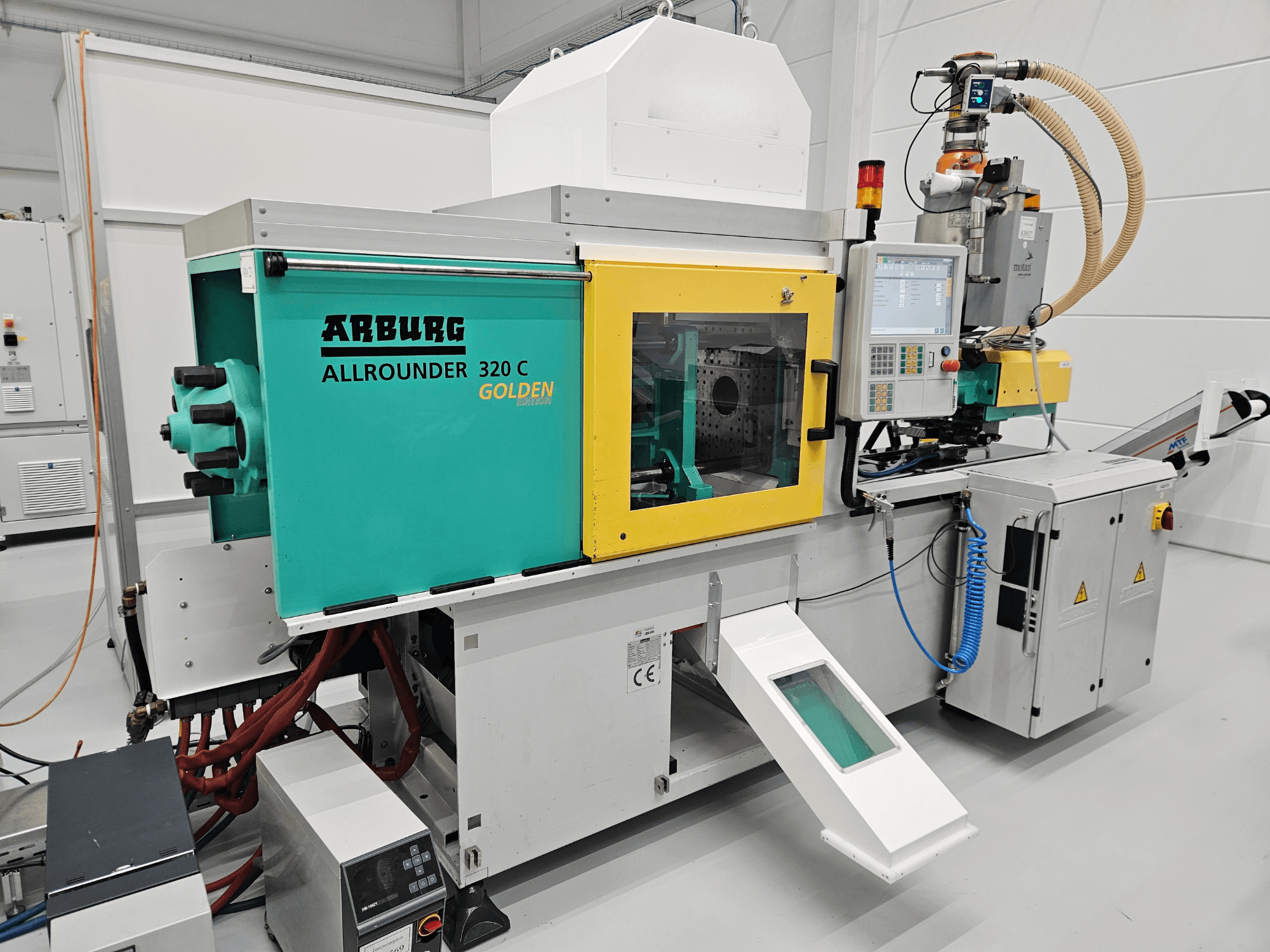 Hydraulic injection moulding machine Arburg 320C 500-170 GE, front view, featuring control panel and colorful exterior design.