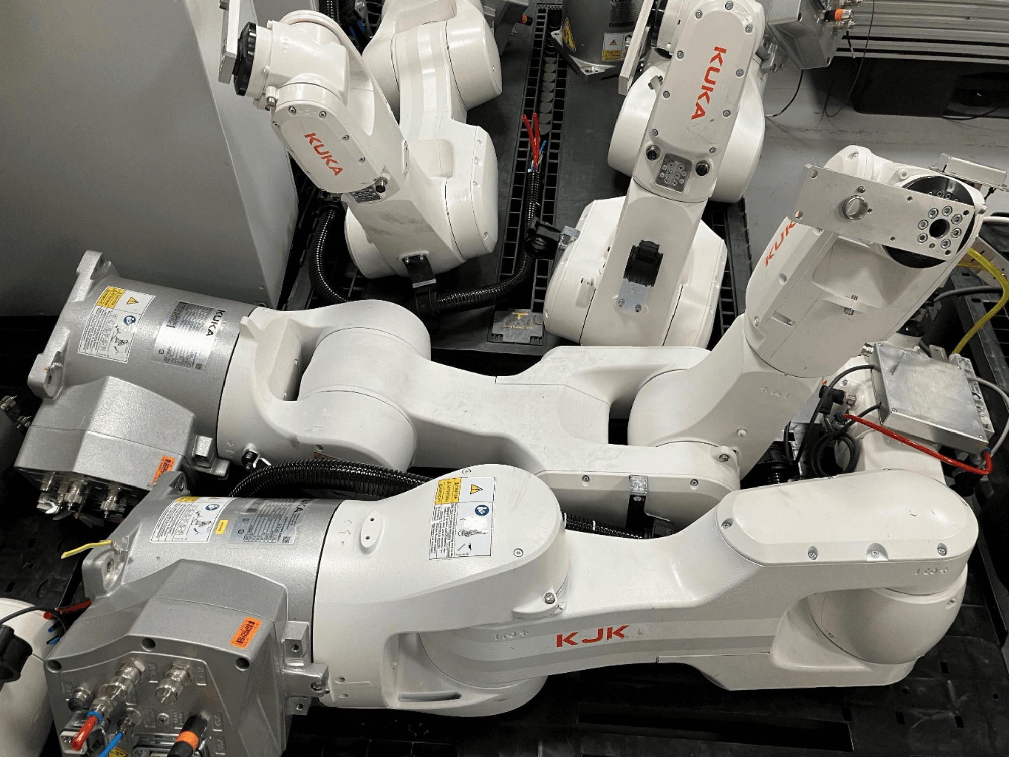 KUKA KR 10 R900 CR robot arm in a side view, showcasing the joint structure, motors, and wiring details.