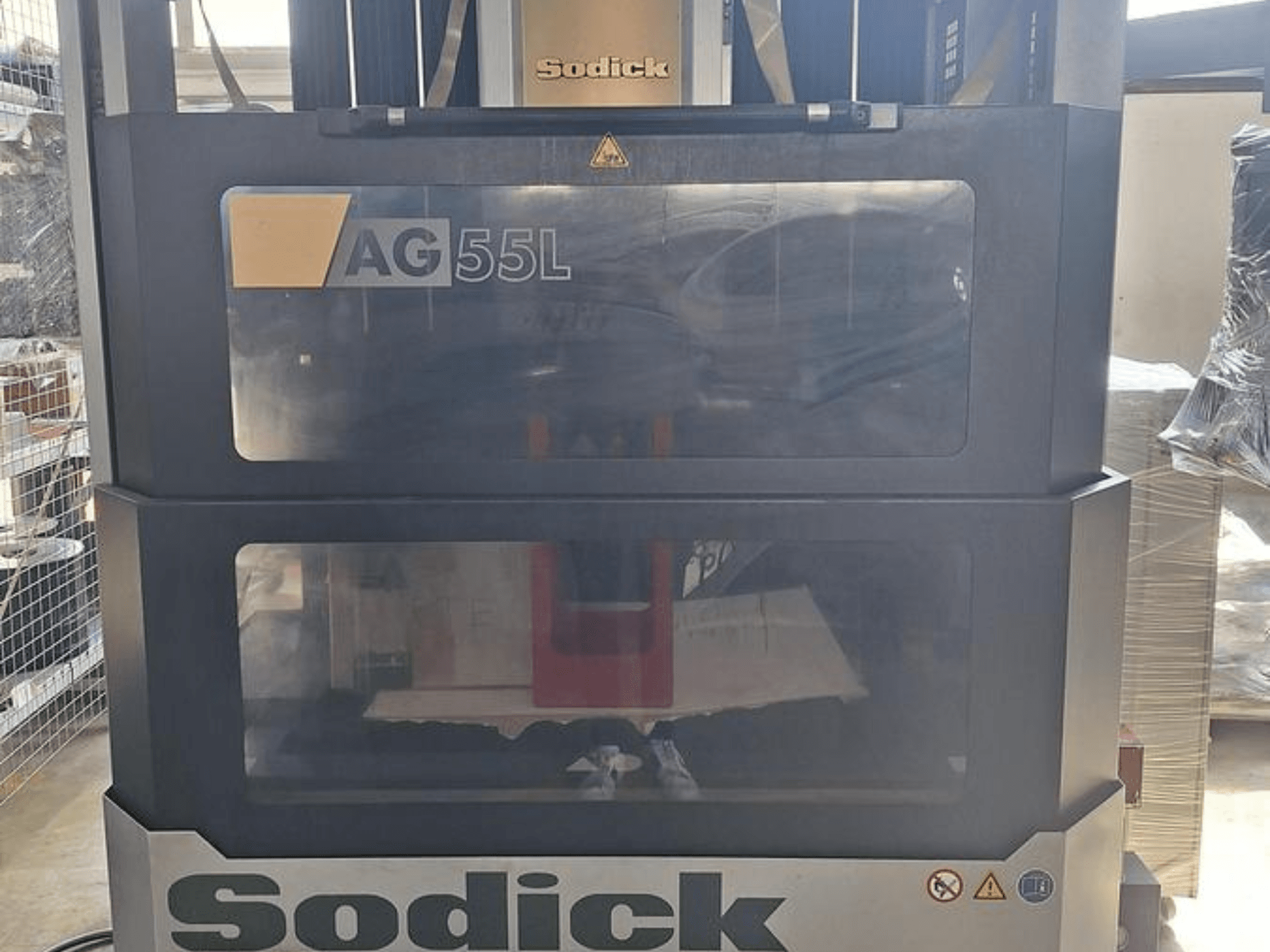 Sodick AG 55L Die-Sinking EDM Machine, front view with controls visible through transparent panels, showcasing workspace inside.