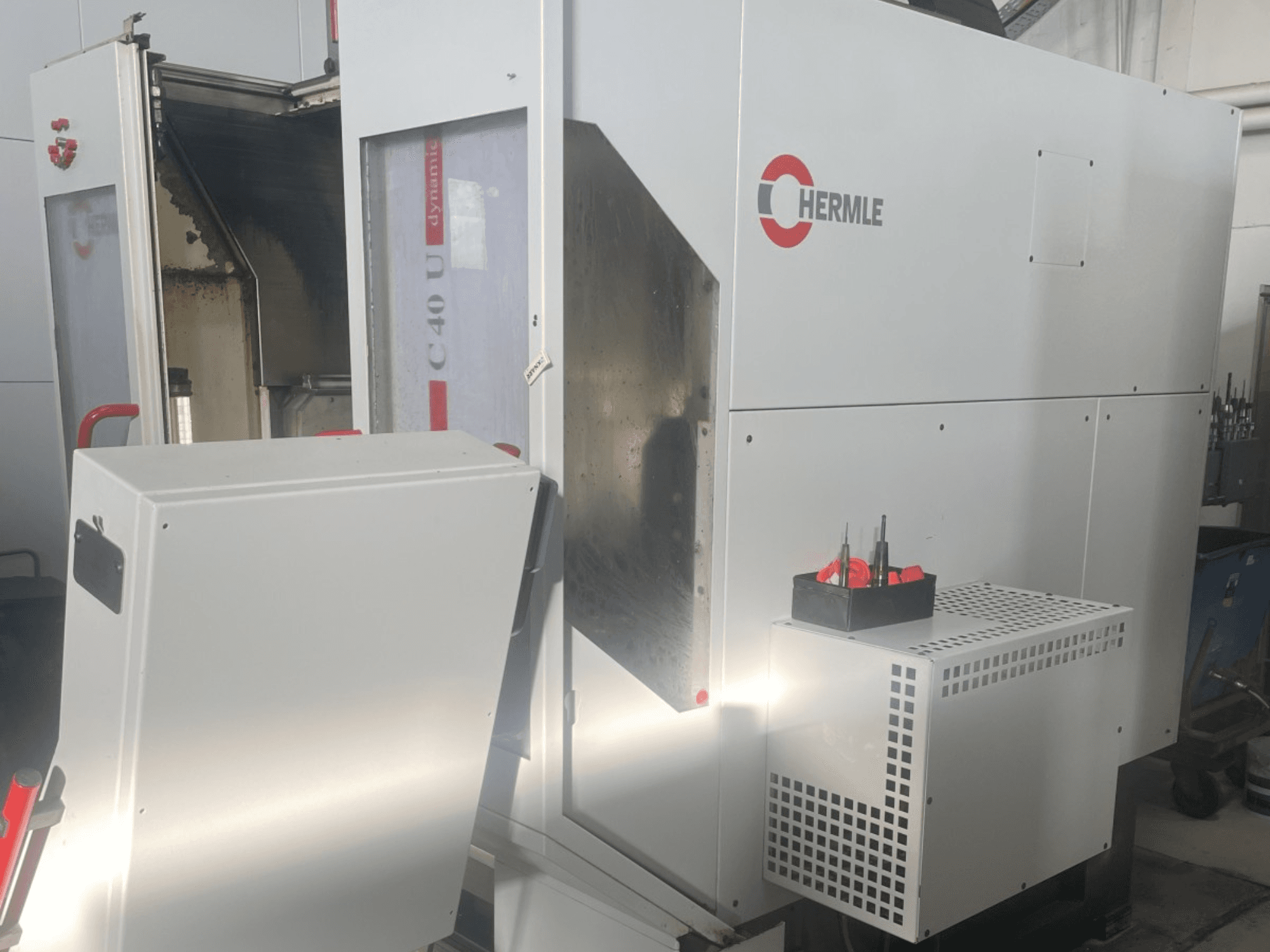 HERMLE C40U Universal Machining Centre in front view, featuring tool holder on the side and visible machine controls.