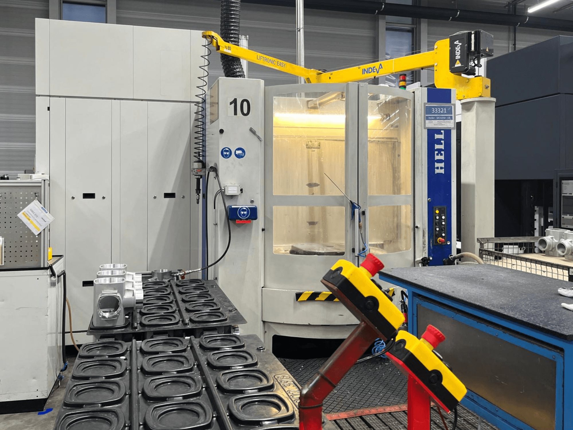 HELLER MCH 250 horizontal machining centre in front view, with aluminum parts and control buttons visible on the side.