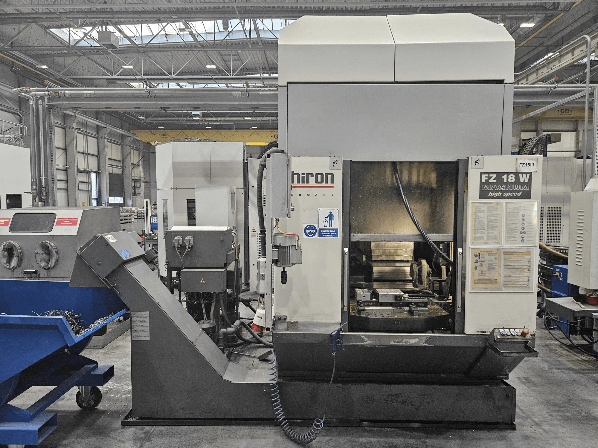 Hiron FZ 18 W Magnum machine, front view, showcasing control panel, spindle, and attached waste disposal chute.