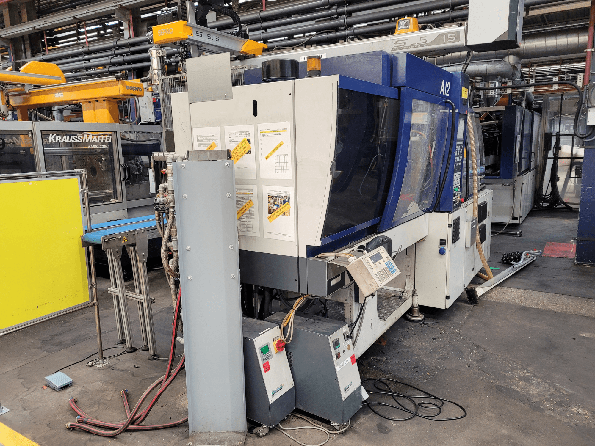 KraussMaffei injection molding machine model KM80-232G, front view, featuring control panel and operational components.