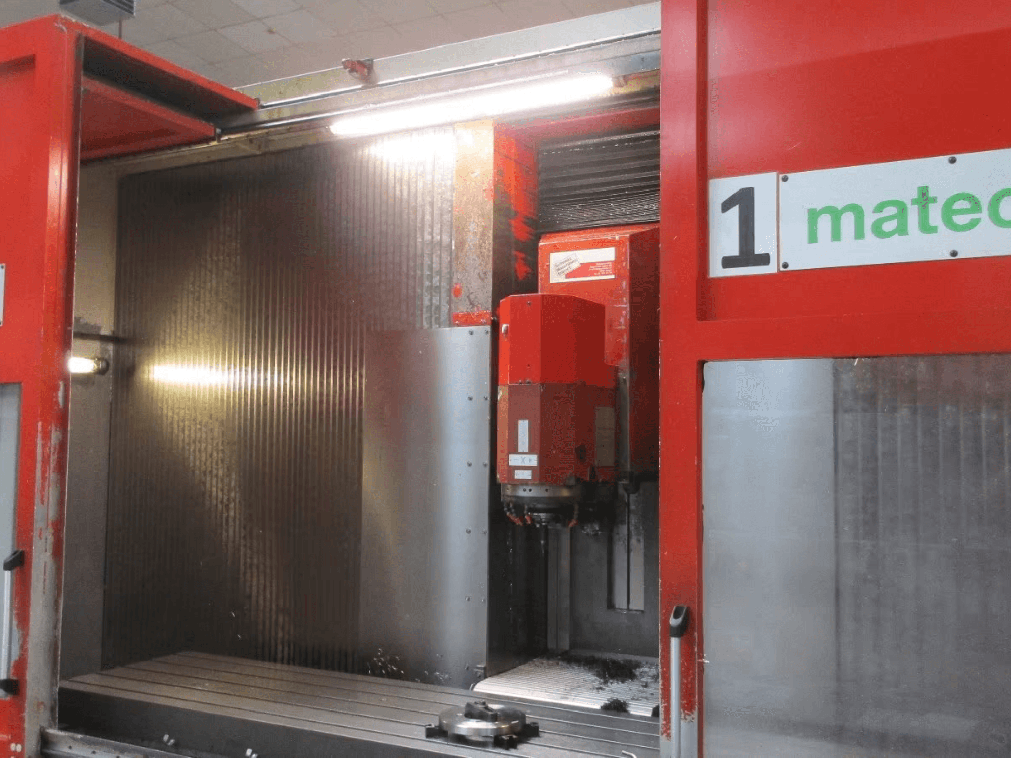 Front view of Matec 30 HV CNC Vertical Machining Centre with visible cutting tool, metal surface, and machine interior details.
