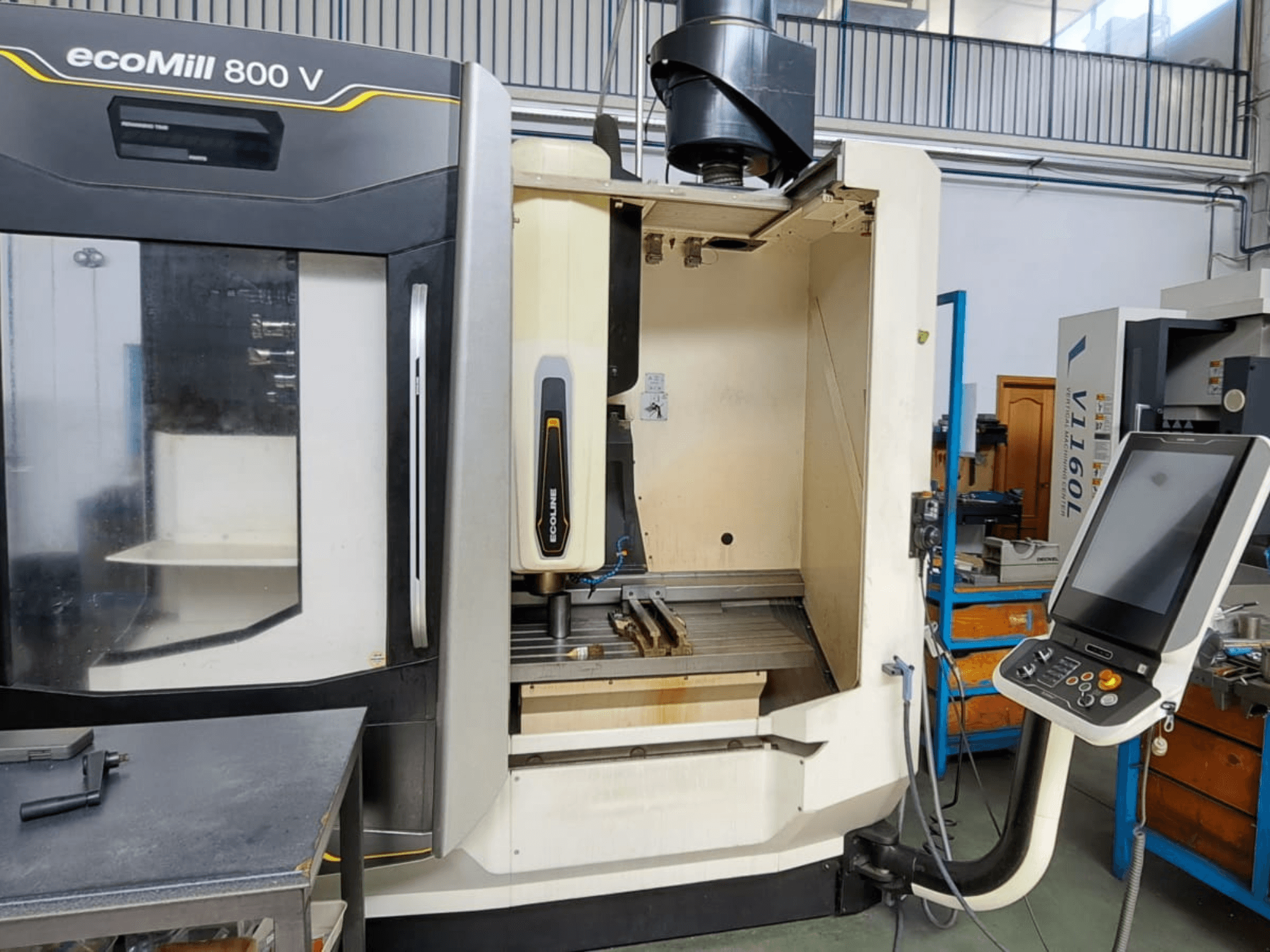 ecoMill 800 V milling machine, front view, features a digital control panel, open work area, and main spindle motor.