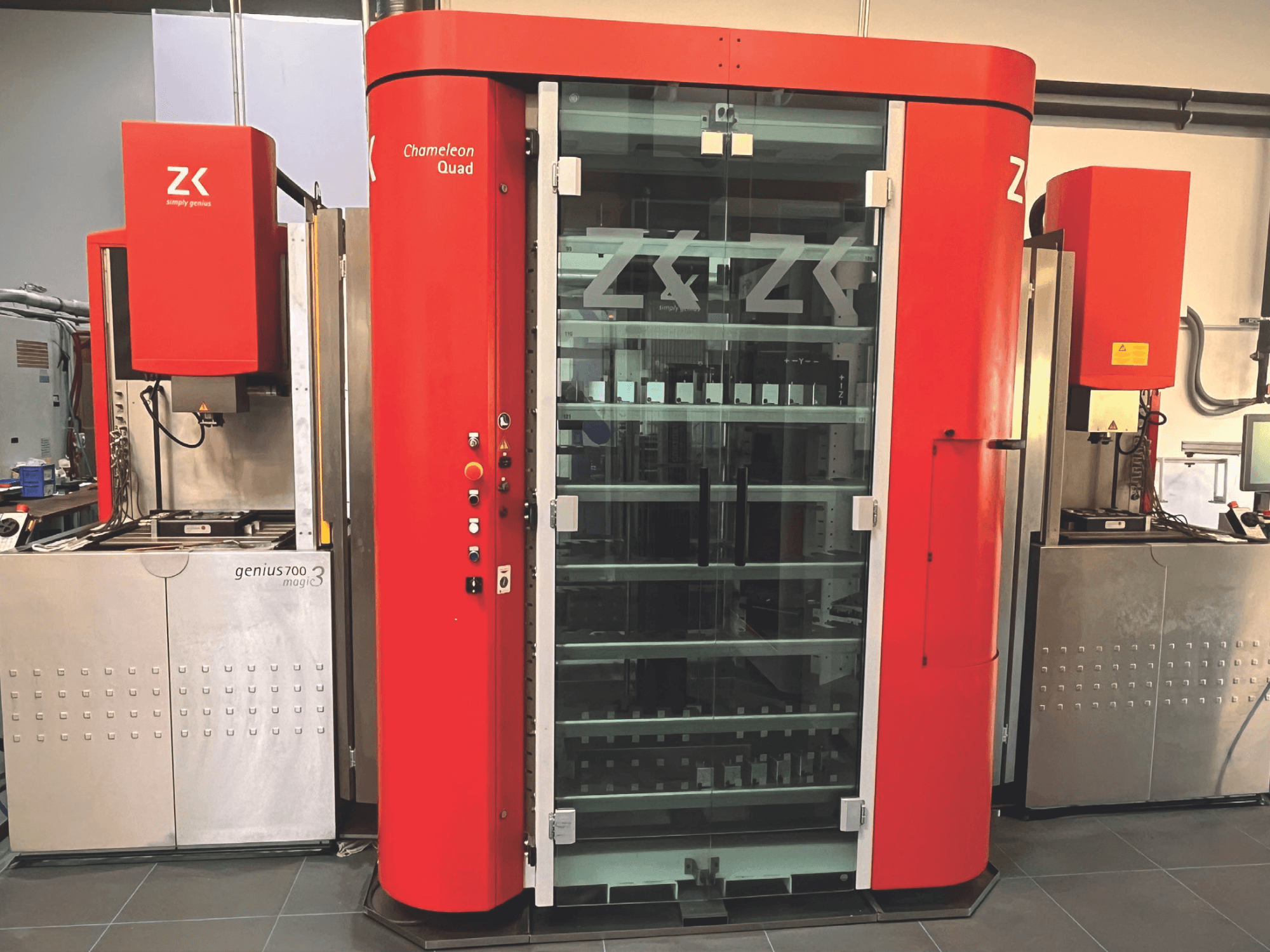 ZK Chameleon Quad, front view, featuring red exterior, glass shelves, and adjacent Genius 700 Magic 3 unit with control panel.