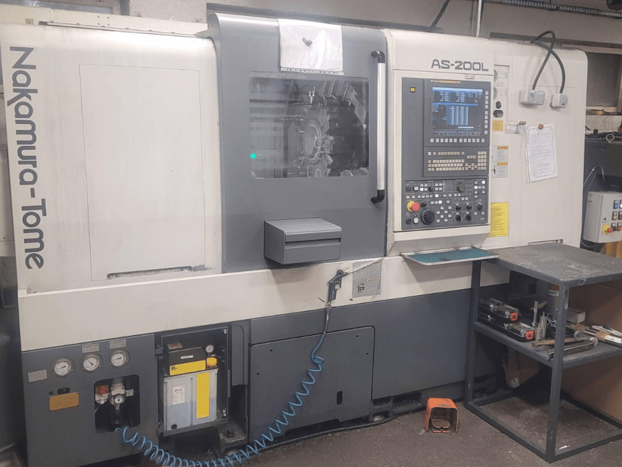 NAKAMURA-TOME AS-200L horizontal turning machine, front view showing control panel, spindle, and machine features.