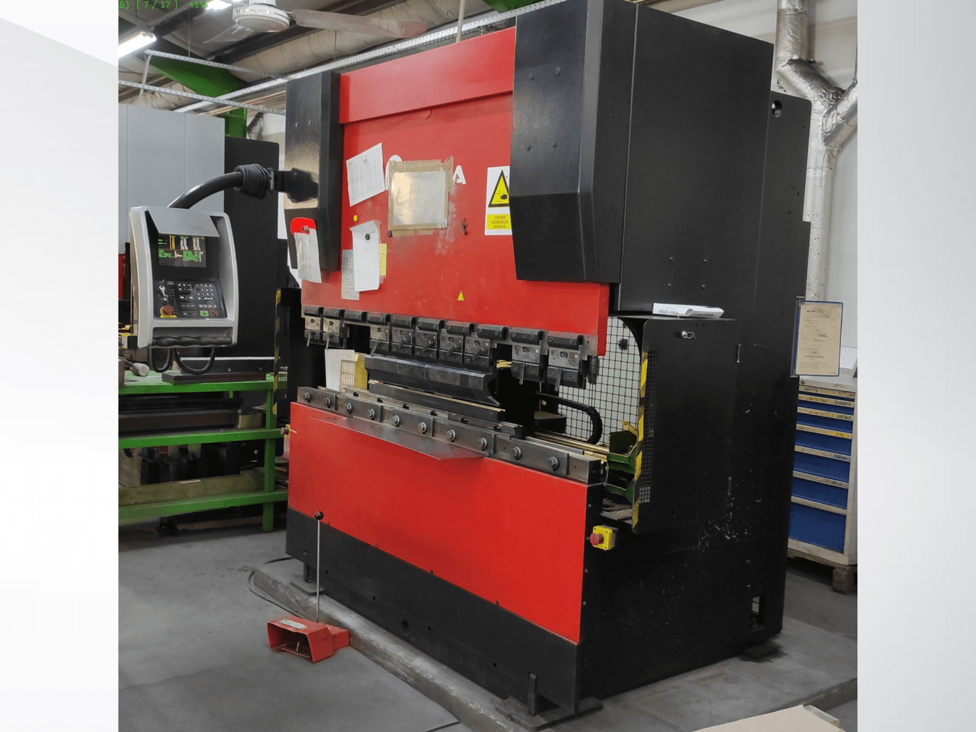AMADA HFB 5020 press brake in red and black, front view, showing control panel, bending tools, and safety features.
