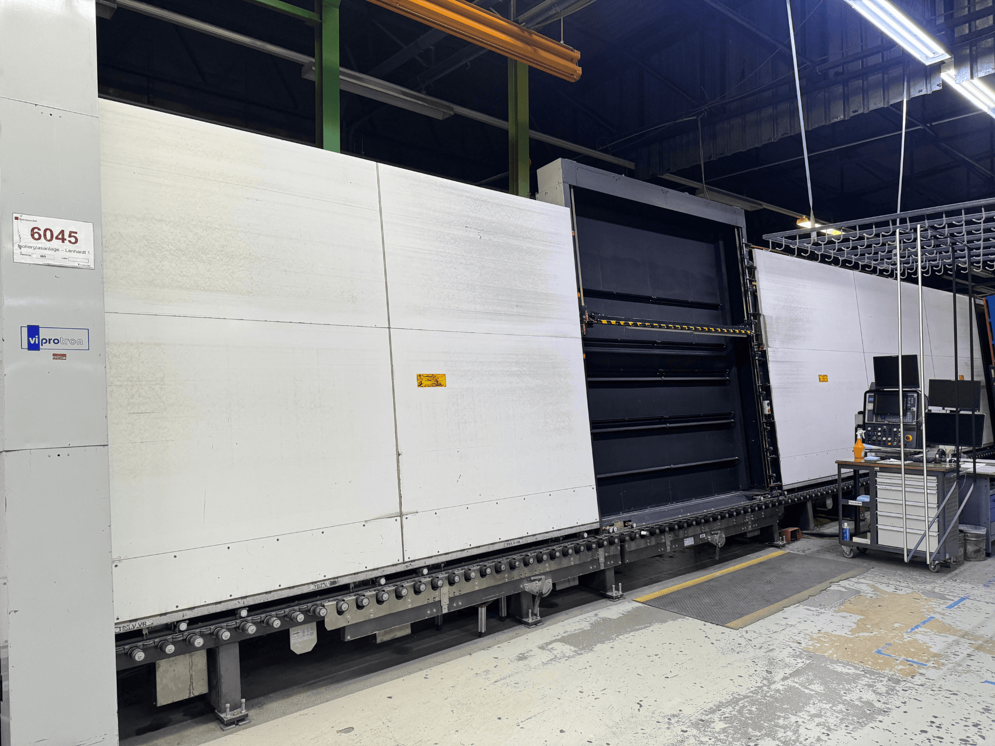 Vipro mold machine front view with open panel, showcasing operational equipment and a workspace beside it. Model 6045.