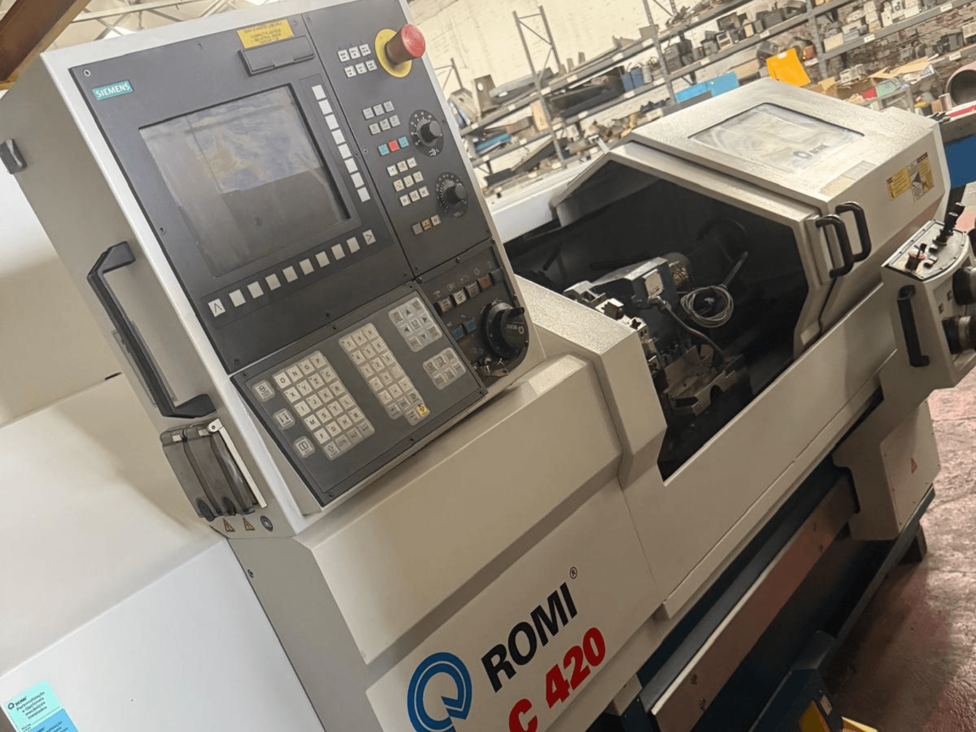 Romi C420 horizontal turning machine with Siemens control panel, side view showcasing intricate design and controls.