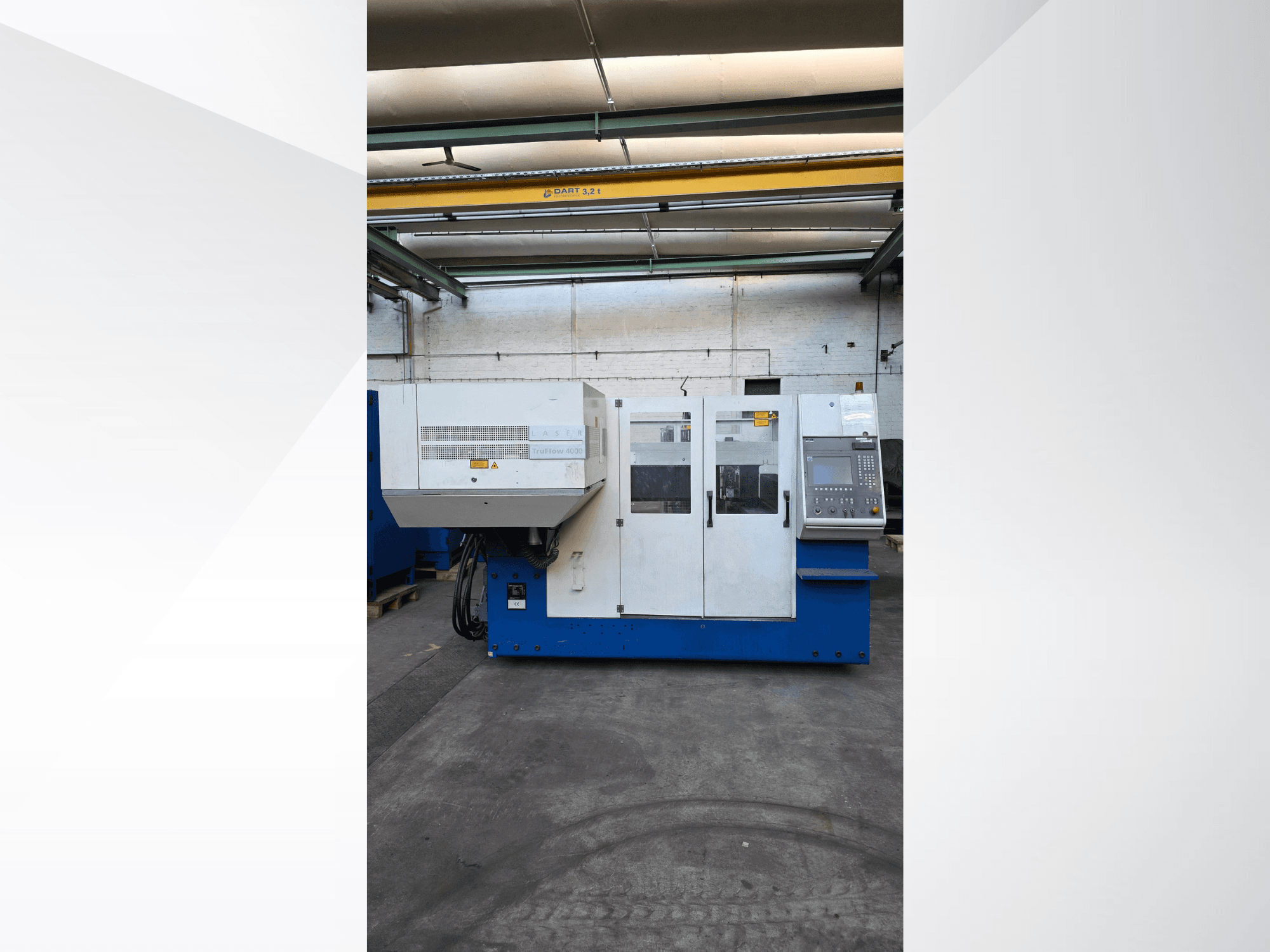 TRUMPF TruLaser 3030 CO2 laser cutting machine, front view, features control panel and safety warnings on exterior.
