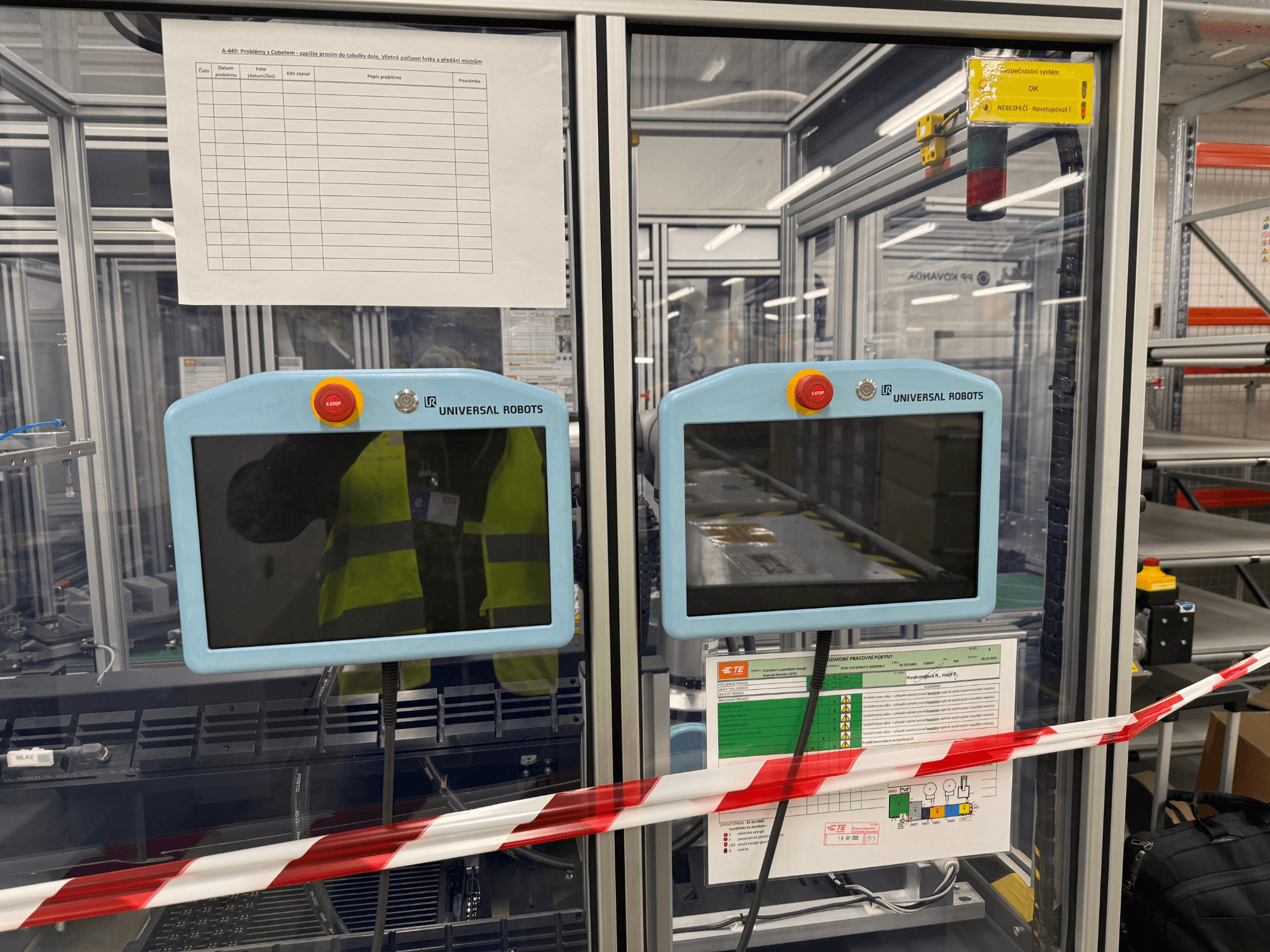 Control panel for Universal Robots UR5 e robot arm, featuring two monitors, emergency stop buttons, and safety instructions.