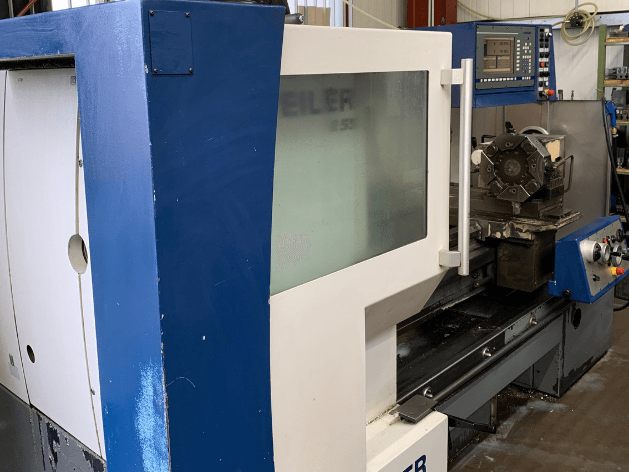 Weiler E55X1000 horizontal turning machine, side view showing control panel and cutting tool setup.