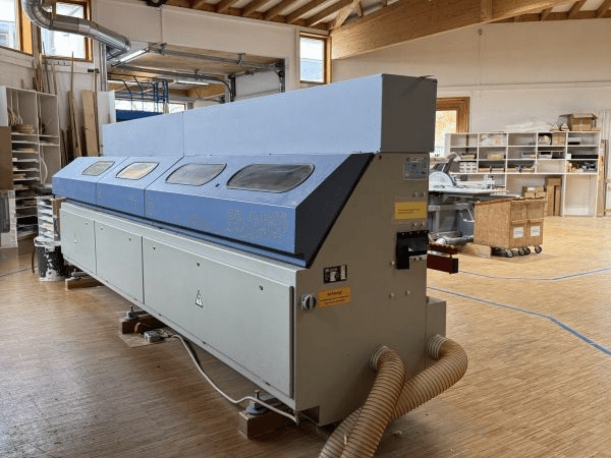 OTT Pacific V6-F edgebander shown from a side view; features a long blue top and control panel with hose attachment.