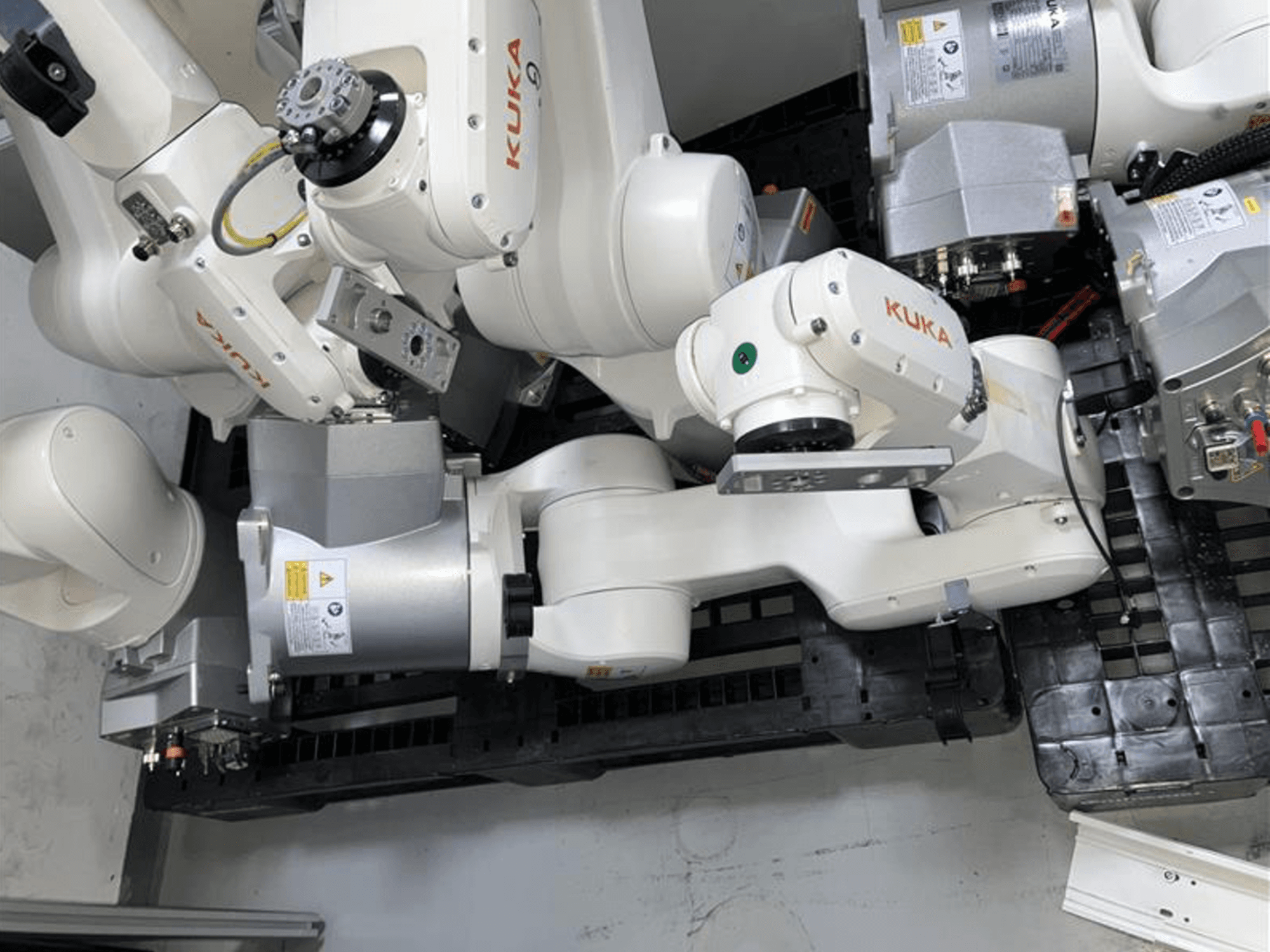KUKA KR 10 R900-2 robot arm viewed from above, showcasing articulated joints and drive motors in an industrial setting.
