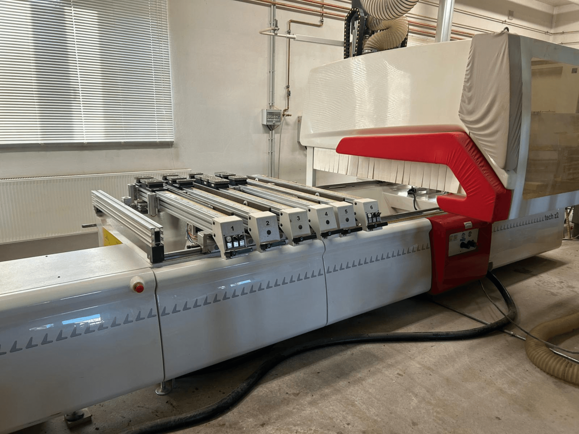 SCM TECH Z2-27-C wood boring machine, side view, showing control panel and rails, with red and white design elements.